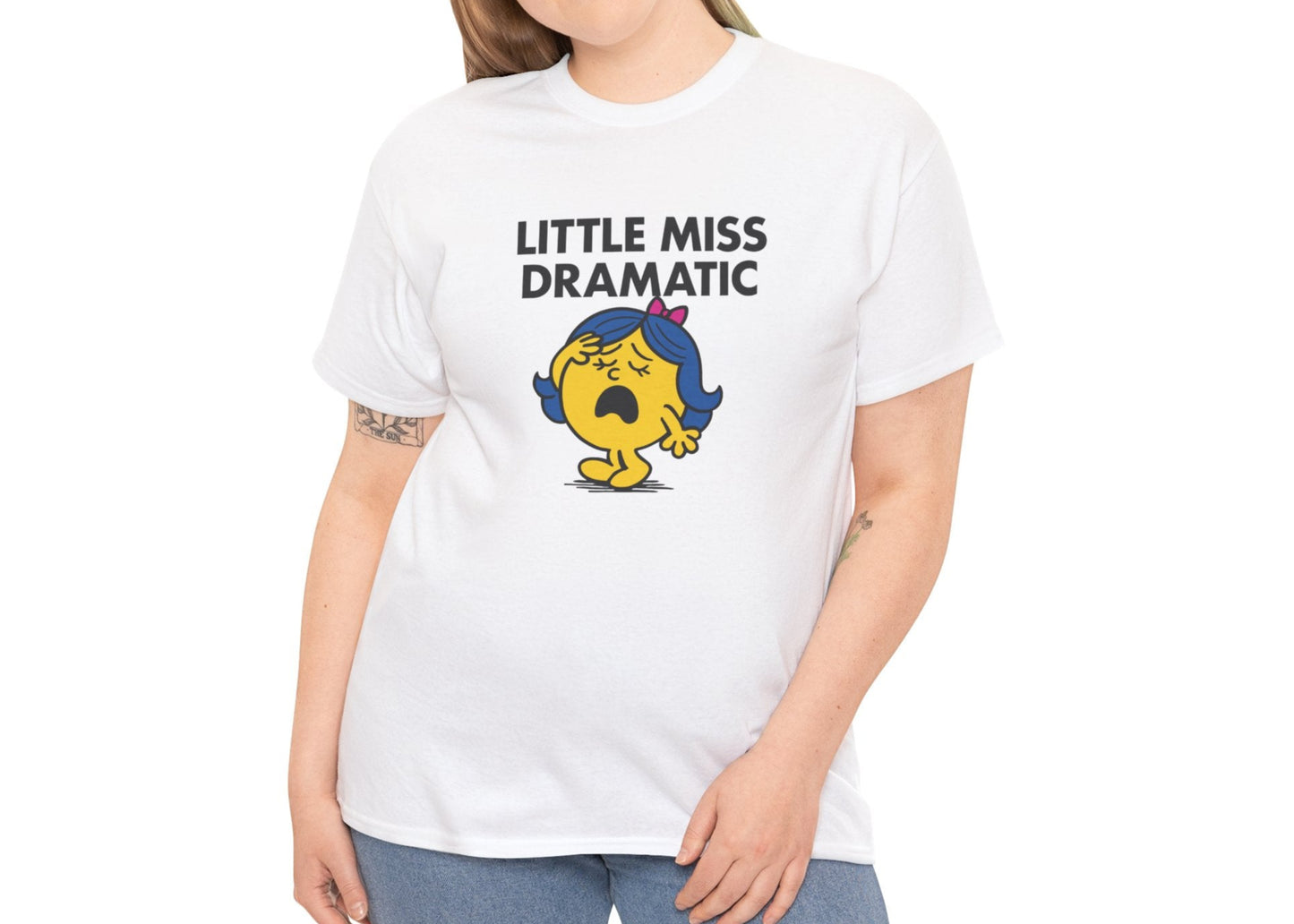 Person wearing the Little Miss Dramatic T-shirt with blue jeans. Part of the Little Miss Meme Character Collection. A Vivid Divergence Sensory Friendly Unisex Tee.