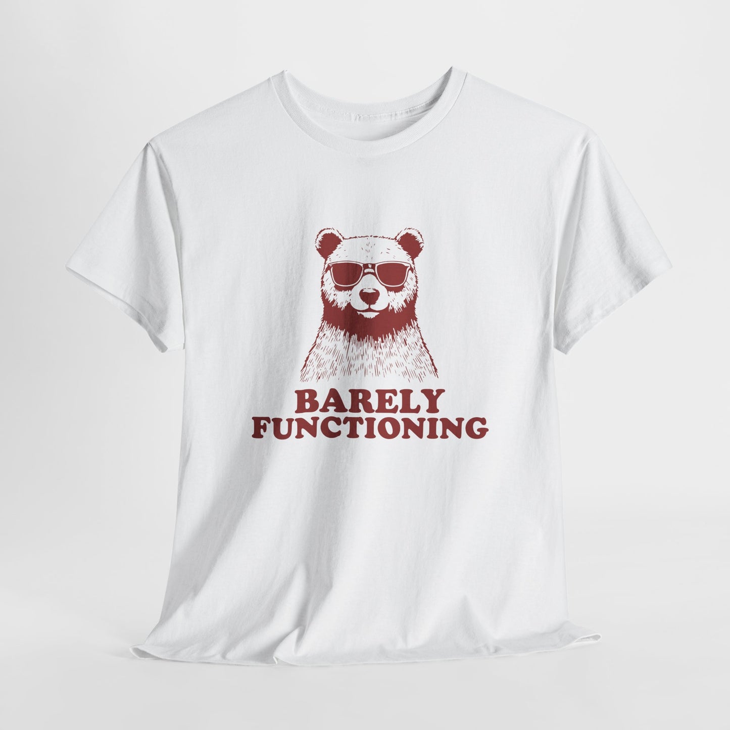 Hanging white T-shirt with a RED bear graphic and "Barely Functioning" text. Part of the Vivid Divergence Sensory Friendly Unisex Tees Range.