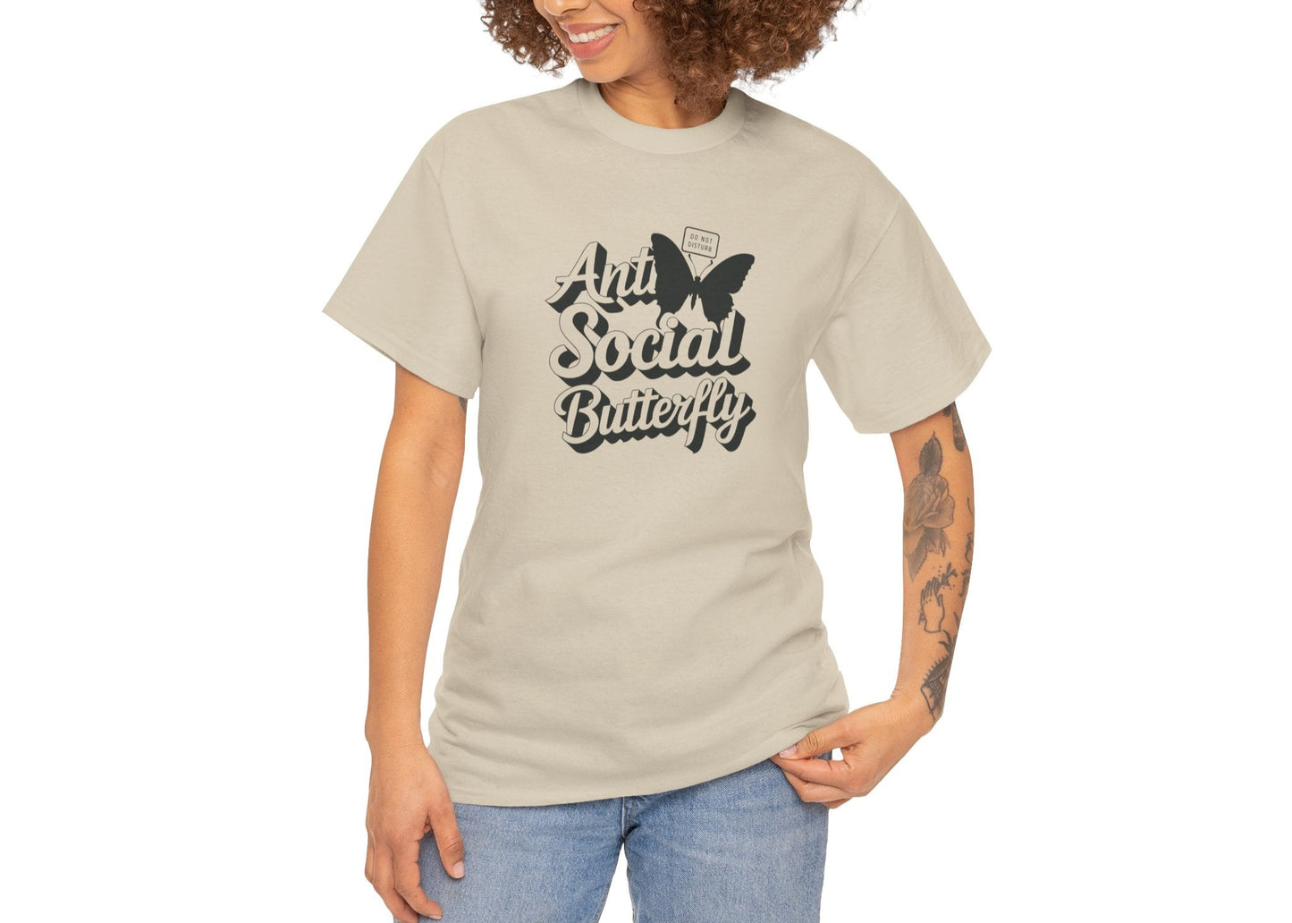 Woman modeling beige Anti-Social Butterfly T-shirt with casual smile. Outgoing energy? Not today. Part of the Vivid Divergence Memewear Collection!