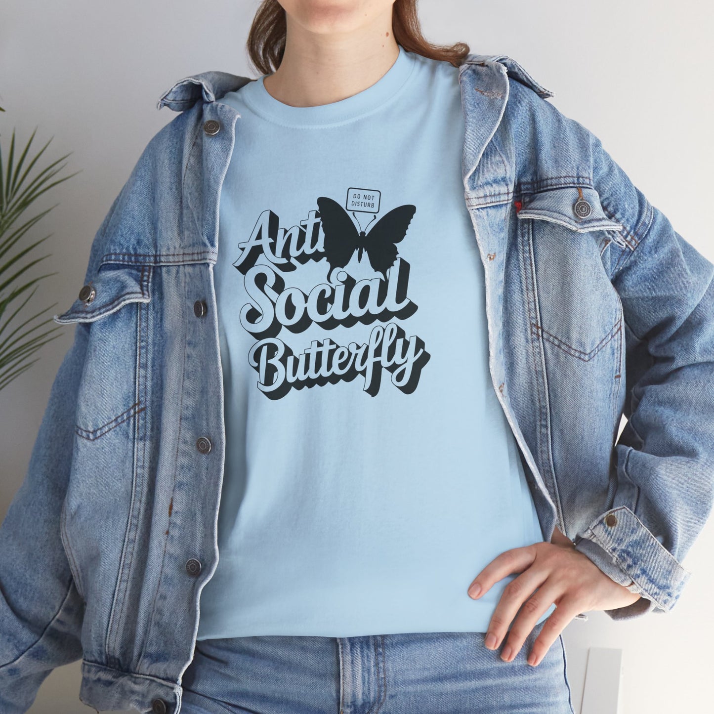 Woman modeling light blue Anti-Social Butterfly T-shirt with casual smile. Outgoing energy? Not today. Part of the Vivid Divergence Memewear Collection!