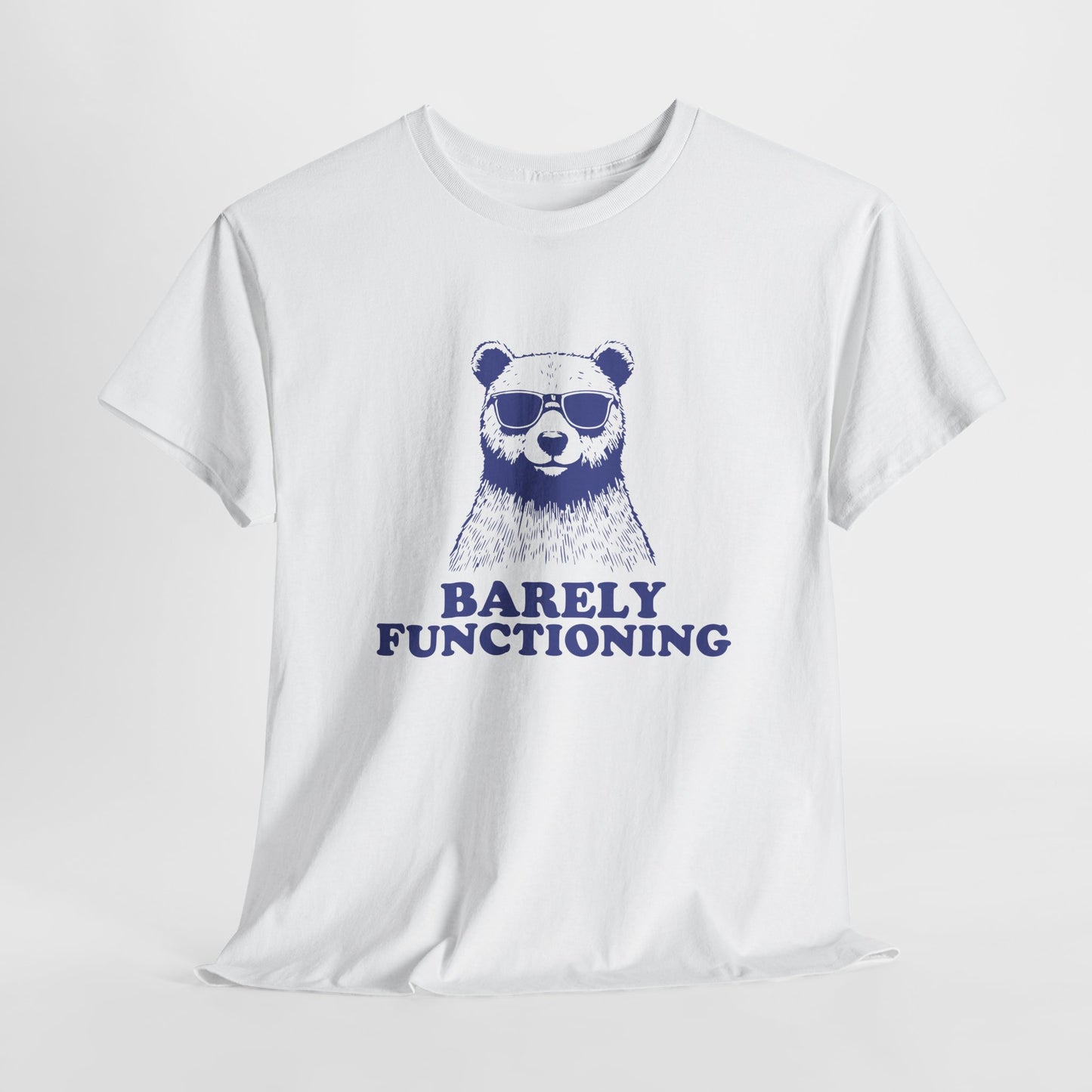 Hanging white T-shirt with a blue bear graphic and "Barely Functioning" text. Part of the Vivid Divergence Sensory Friendly Unisex Tees Range.