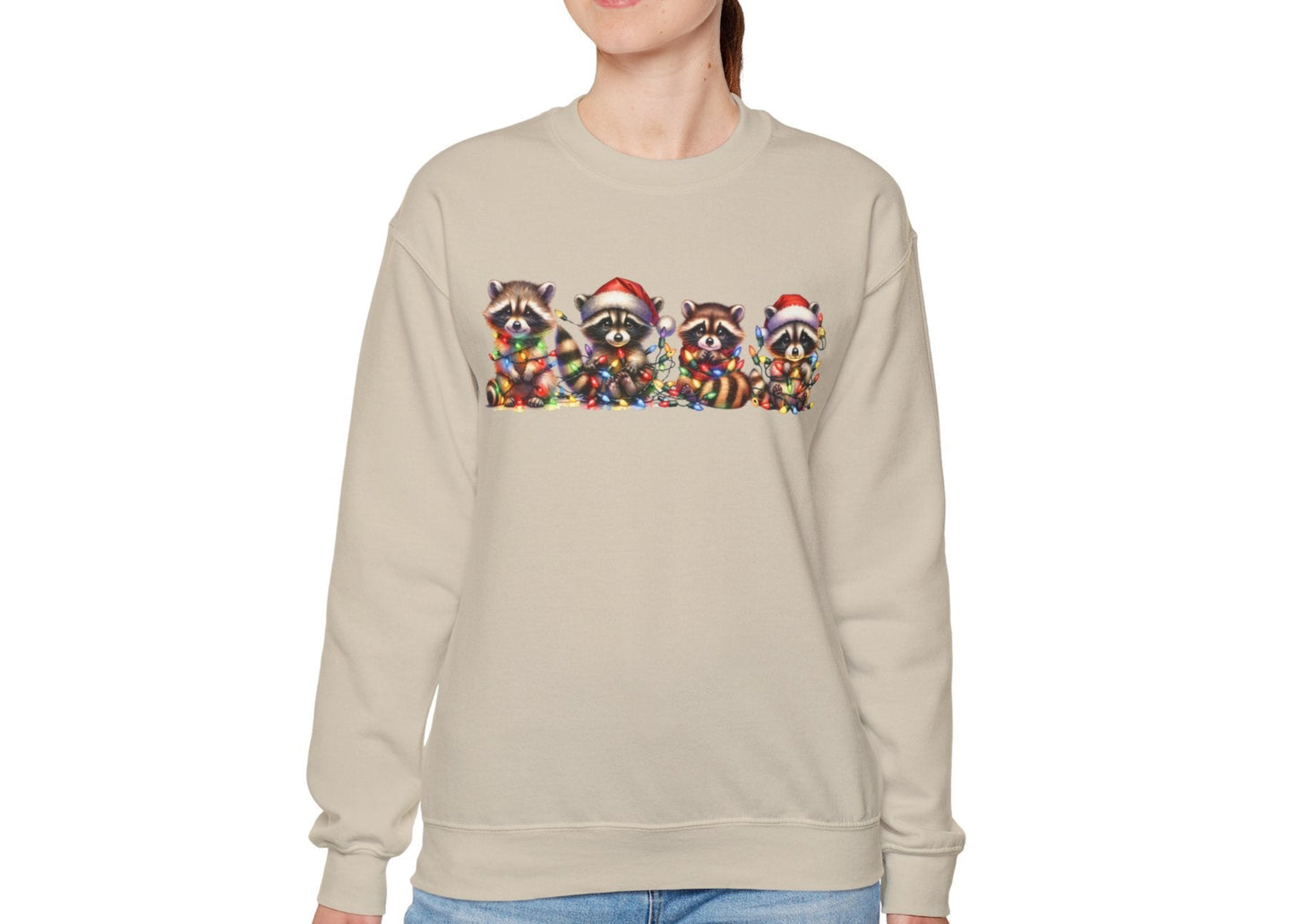 Model wearing a beige sweatshirt featuring a festive illustration of raccoons in Christmas attire causing holiday chaos. Part of the Vivid Divergence Sensory Friendly Unisex Sweater Jumper Range.