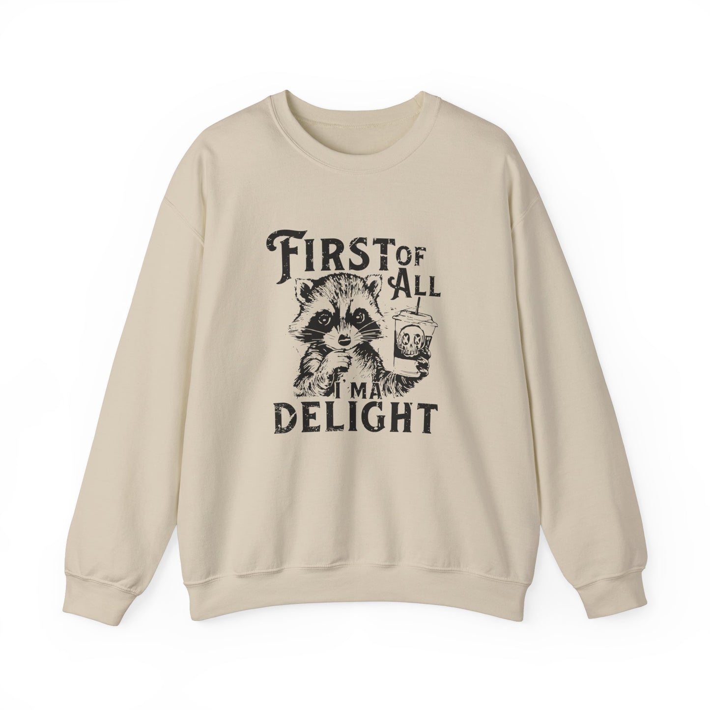 Front view of a beige sweater jumper with the text "First of All, I’m a Delight" and a cartoon raccoon illustration. Part of the Vivid Divergence Sensory Friendly Unisex Sweater Jumper Range.