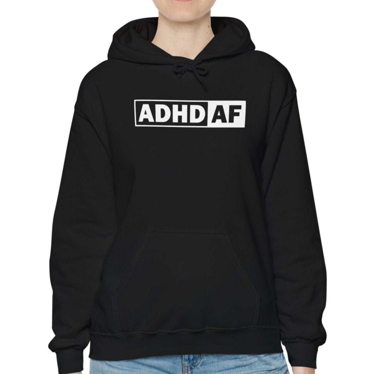 Model wearing a black hoodie with the text "ADHD AF" in bold white lettering inside a rectangular border. Part of the Vivid Divergence Sensory Friendly Unisex Hoodie Range.