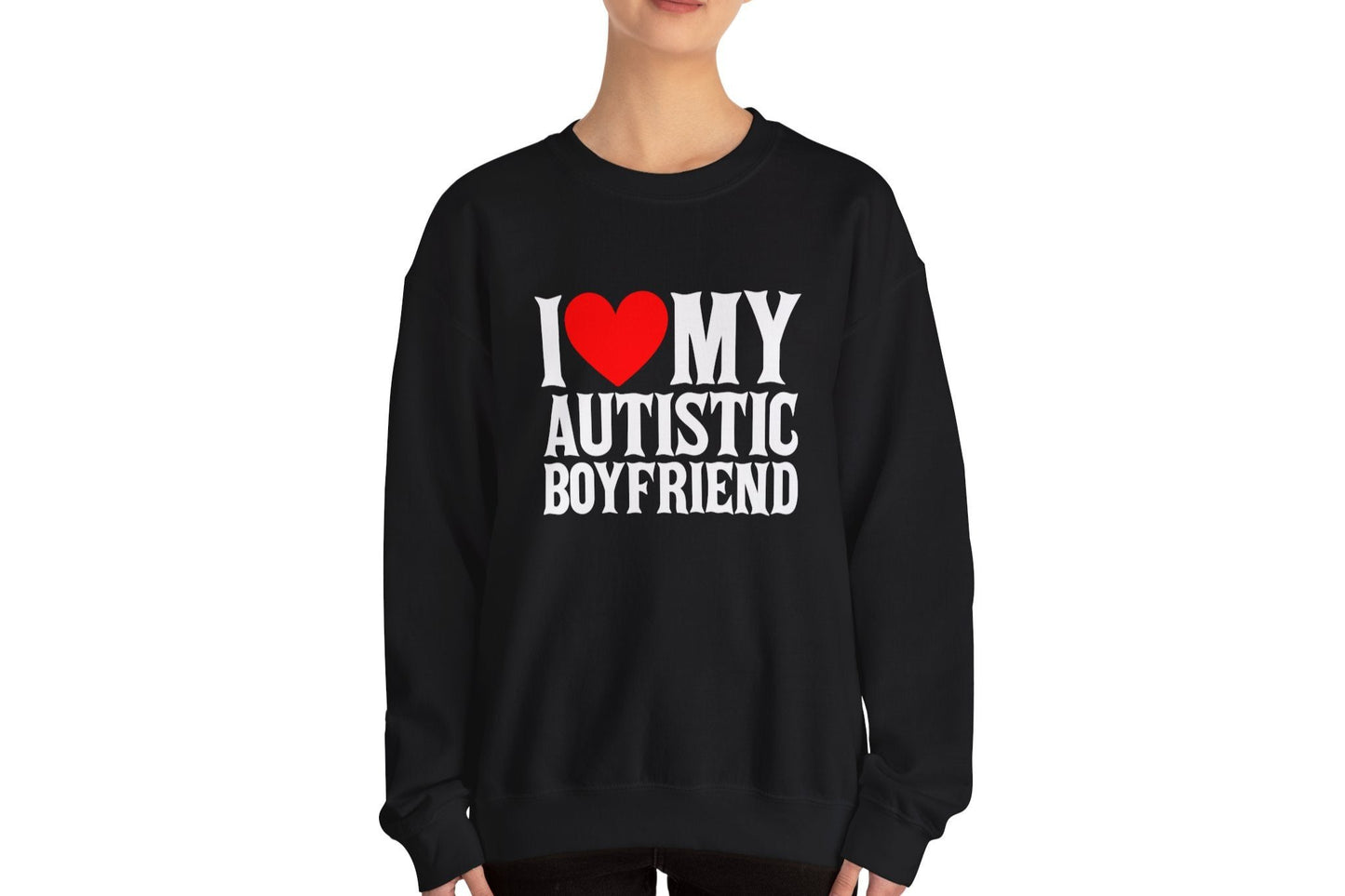 Model wearing a black sweater jumper with the text "I ❤️ My Autistic Boyfriend" in bold white and red lettering. Part of the Vivid Divergence Sensory Friendly Unisex Sweater Jumper Range.