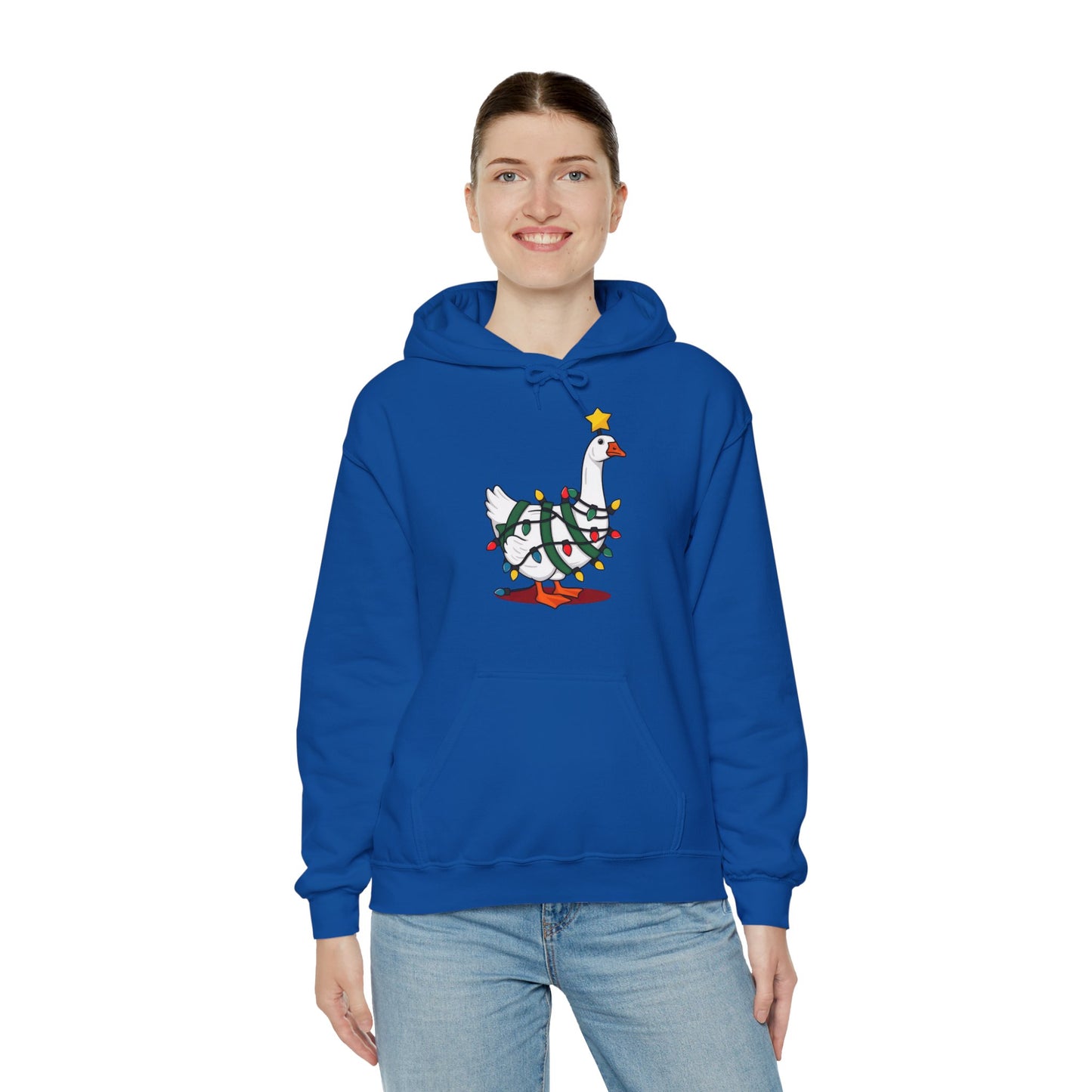 Model wearing a blue hoodie featuring a festive illustration of a goose wearing a Santa hat and stringing Christmas lights, with the text "Goose on the Loose." Part of the Vivid Divergence Sensory Friendly Unisex Hoodie Range.