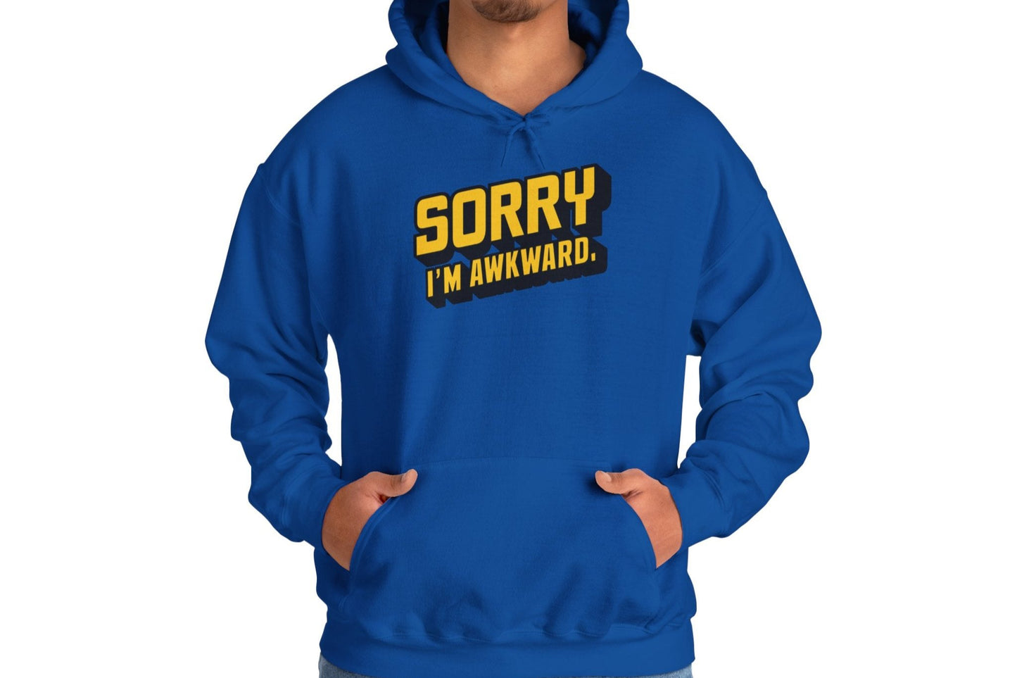Model wearing a blue hoodie featuring the text "Sorry I'm Awkward" in bold yellow and white lettering. Part of the Vivid Divergence Sensory Friendly Unisex Hoodie Range.