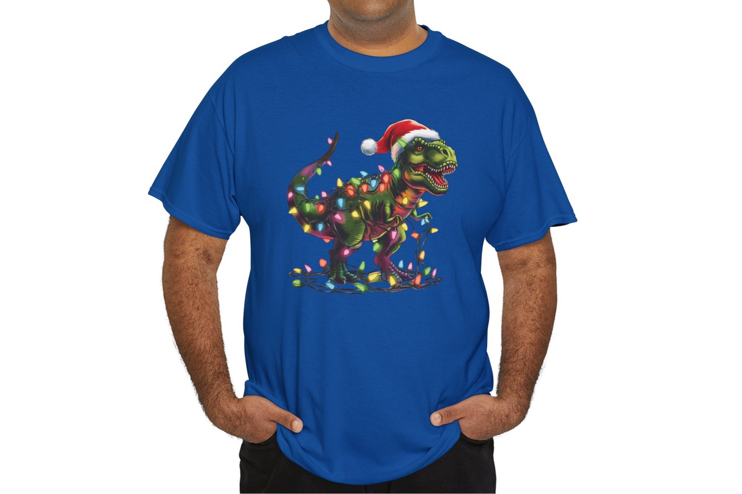 Model wearing a blue T-shirt with a playful T-Rex tangled in Christmas lights, wearing a Santa hat. Part of the Vivid Divergence Sensory Friendly Unisex Tees Range.