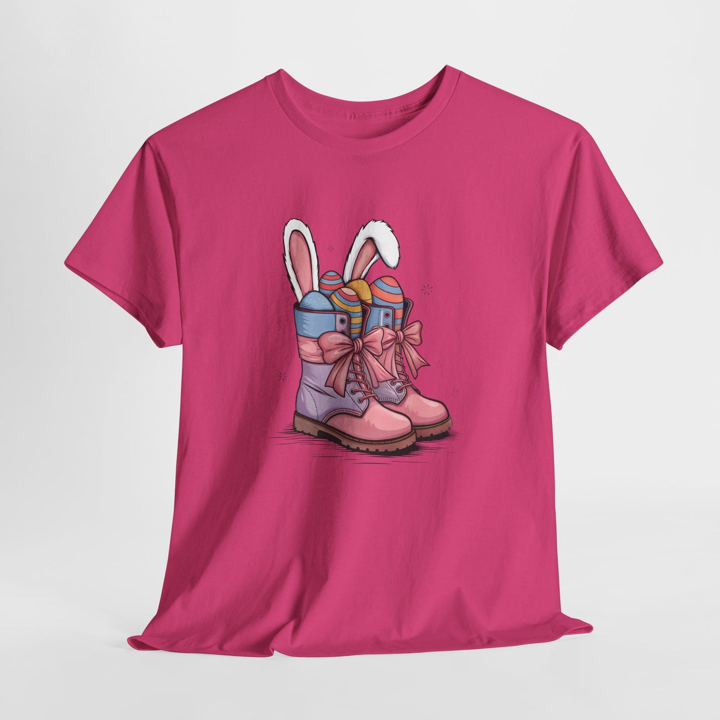 Bright Pink T-shirt hanging, featuring a stylish Easter cowgirl boots design with bunny ears and pastel eggs, a playful holiday tee. Hop into the season in style and shop Easter shirts online today!