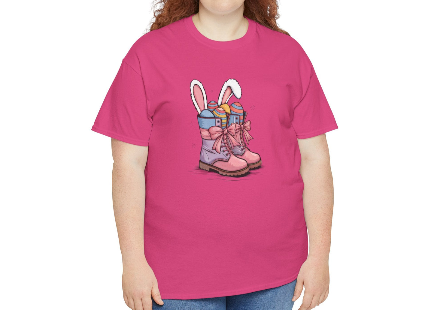 Woman wearing a bright pink Easter T-shirt featuring a cute cowgirl boots design with bunny ears and pastel eggs, a trendy Easter choice. Hop into the season in style and shop Easter shirts online today!