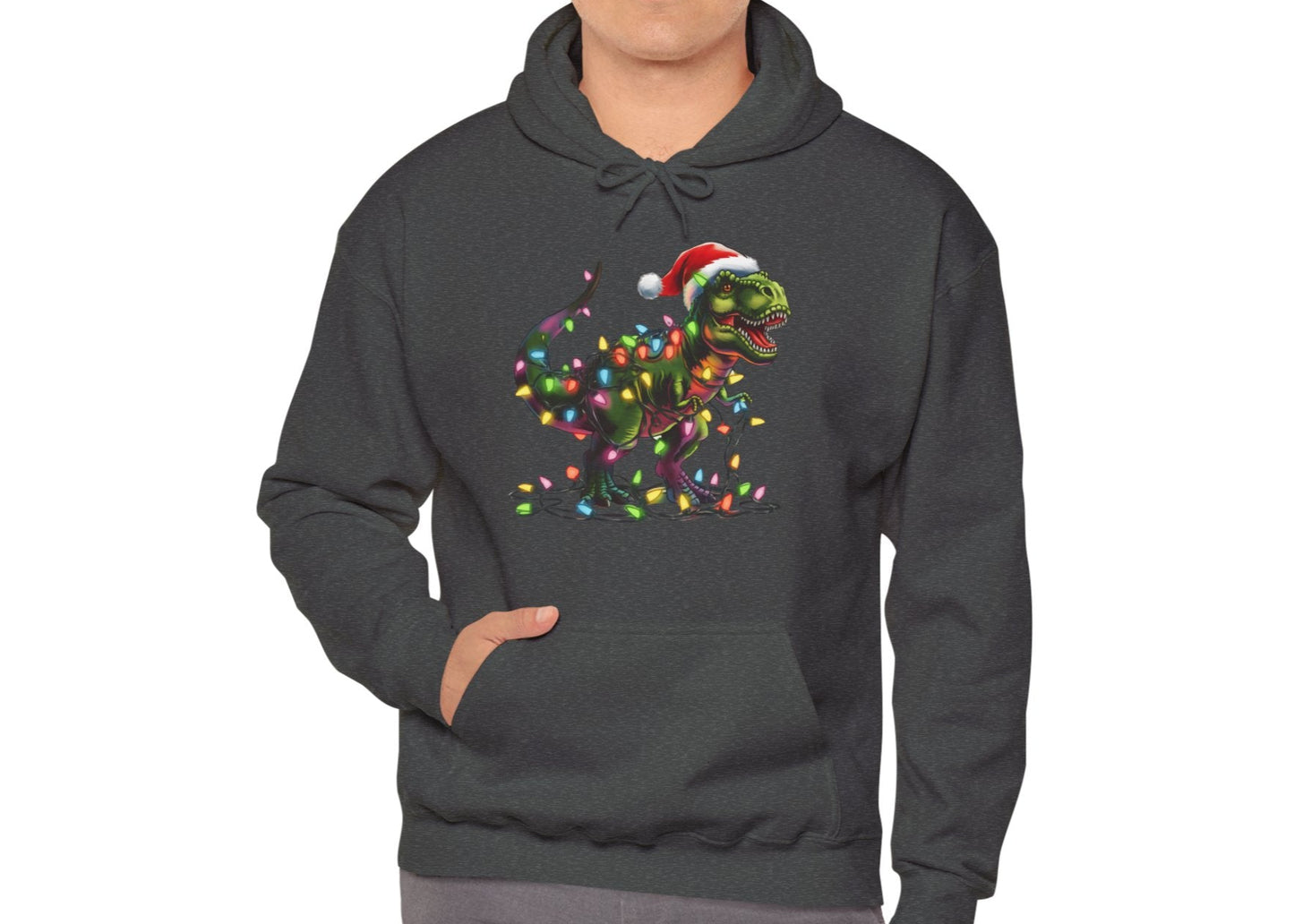 Model wearing a dark gray hoodie featuring a holiday T-Rex wrapped in Christmas lights with a Santa hat. Part of the Vivid Divergence Sensory Friendly Hoodie Range.