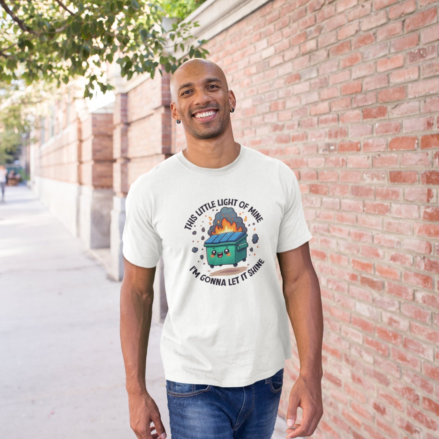 Person wearing a white T-shirt featuring a colorful dumpster fire graphic with the text "This Little Light Of Mine I'm Going To Let It Shine." Part of the Vivid Divergence Sensory Friendly Unisex Tees Range.