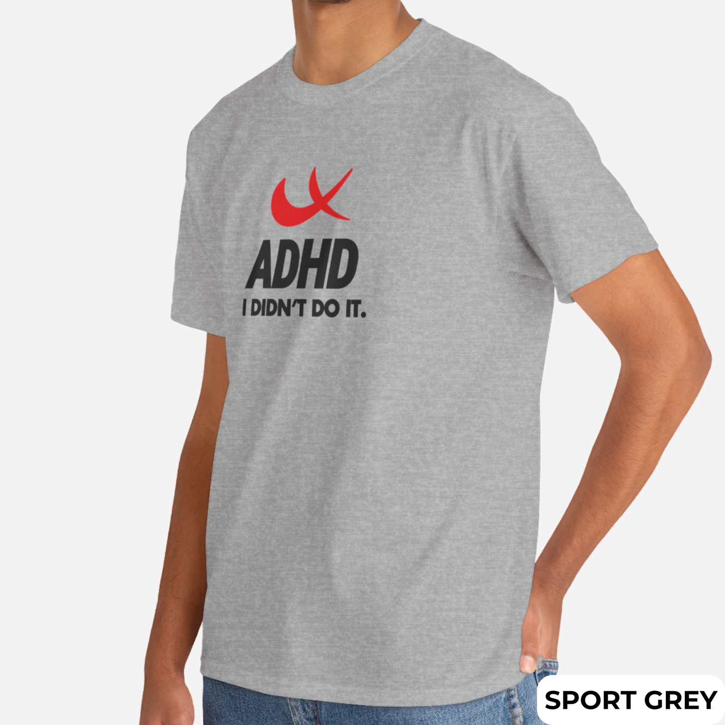 Side view of a gray T-shirt featuring the phrase "ADHD I Didn't Do It" with a red swoosh parody of the Nike symbol. Part of the Vivid Divergence Sensory Friendly Unisex Tees Range.