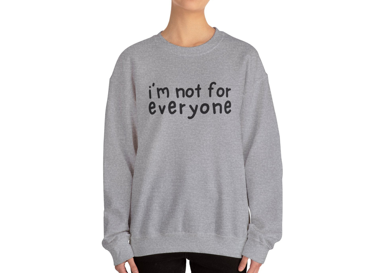 Model wearing a gray sweater jumper with the text "I'm Not For Everyone" in bold black lettering. Part of the Vivid Divergence Sensory Friendly Unisex Sweater Jumper Range.