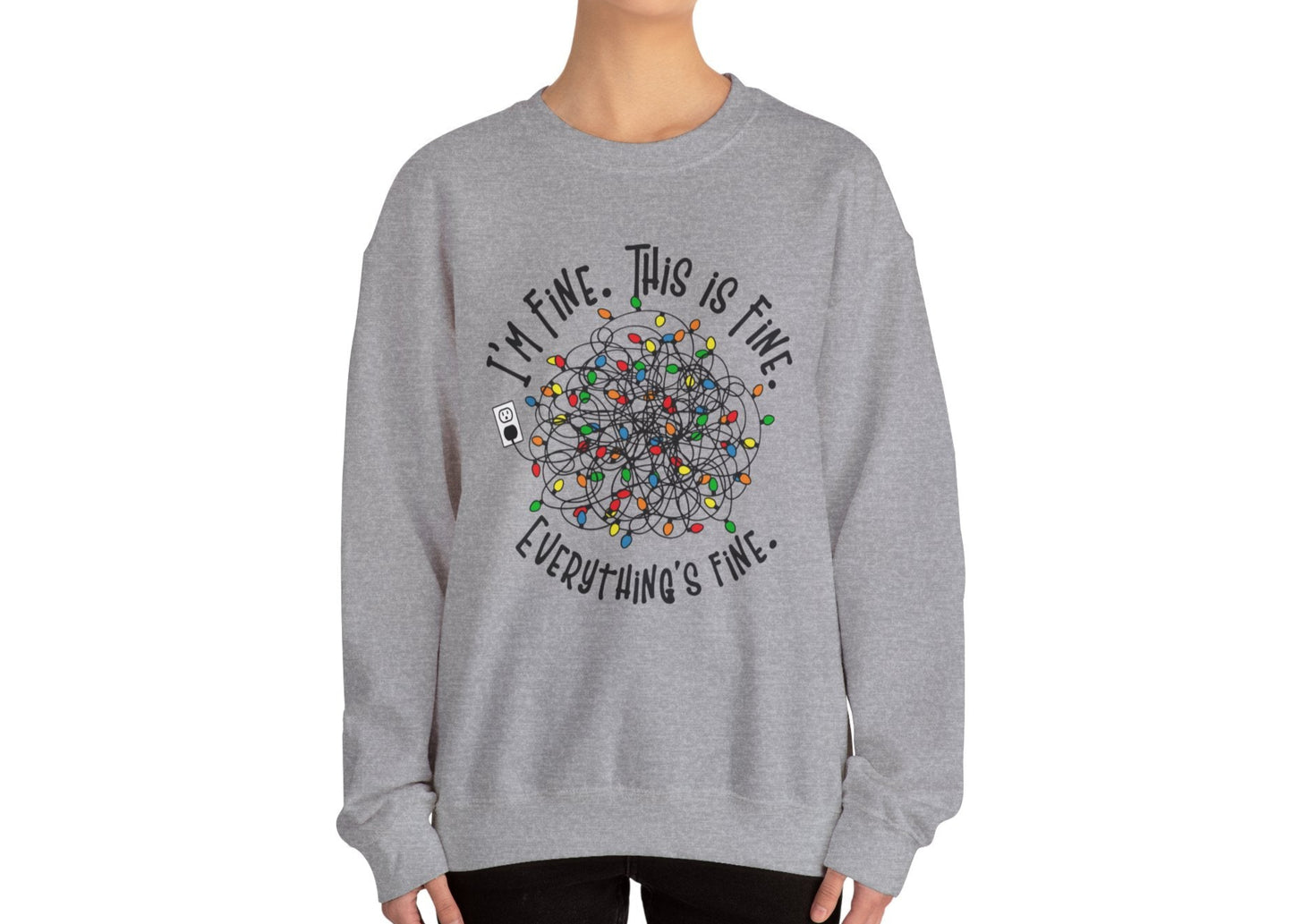 Model wearing a gray sweatshirt with a festive tangle of Christmas lights and the phrase "I'm Fine. This is Fine. Everything's Fine." Part of the Vivid Divergence Sensory Friendly Sweatshirt Range.