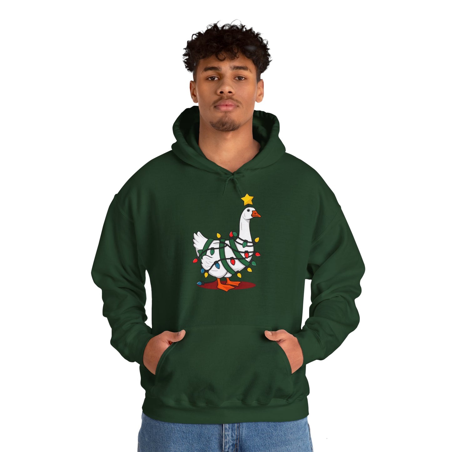 Model wearing a green hoodie featuring a festive illustration of a goose wearing a Santa hat and stringing Christmas lights, with the text "Goose on the Loose." Part of the Vivid Divergence Sensory Friendly Unisex Hoodie Range.