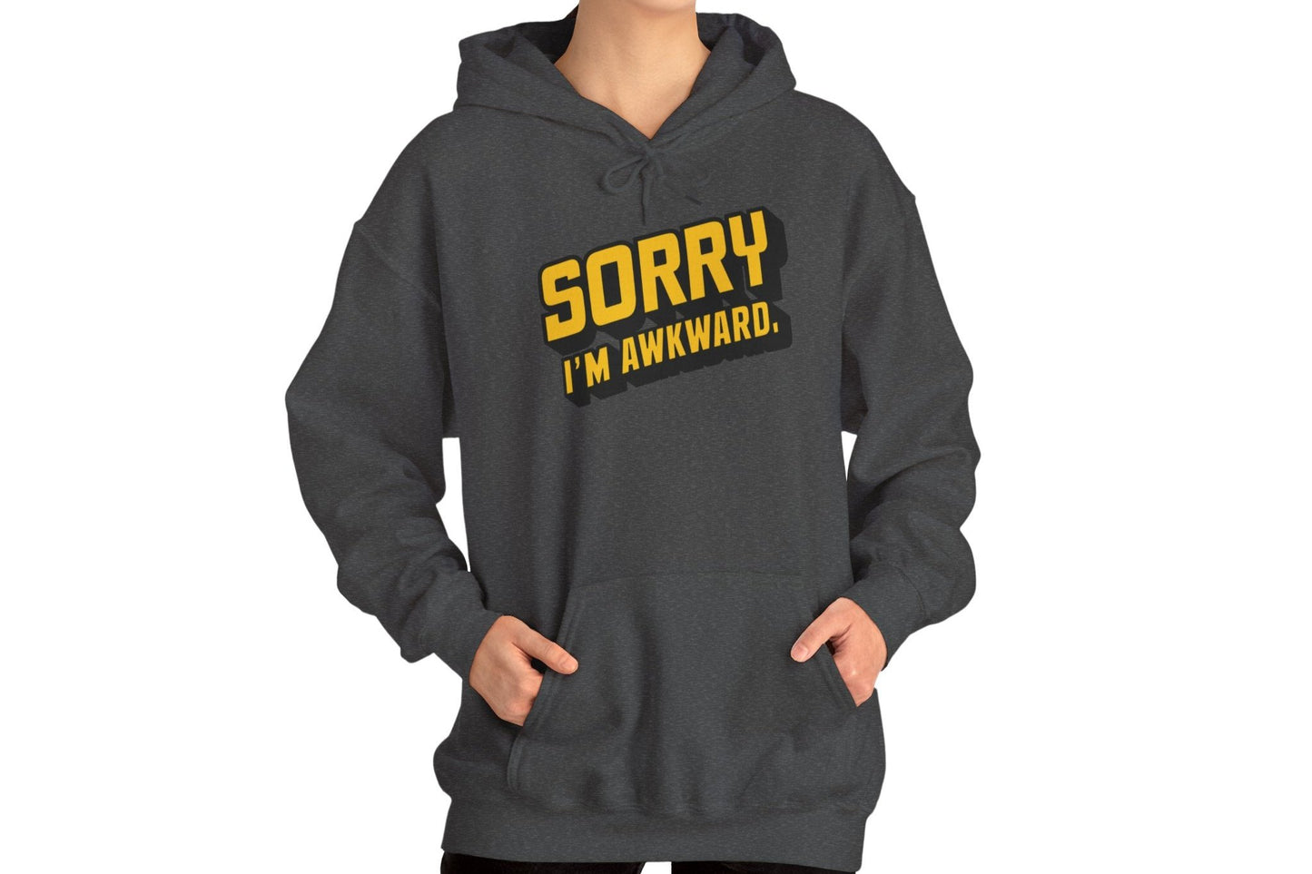 Model wearing a grey hoodie featuring the text "Sorry I'm Awkward" in bold yellow and white lettering. Part of the Vivid Divergence Sensory Friendly Unisex Hoodie Range.