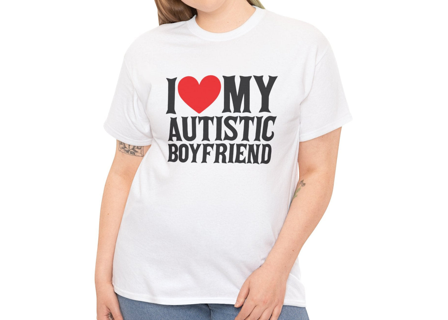 Woman wearing a white "I ❤️ MY AUTISTIC BOYFRIEND" T-shirt, smiling and posing casually. Part of the Vivid Divergence Sensory Friendly Unisex Tees Range.