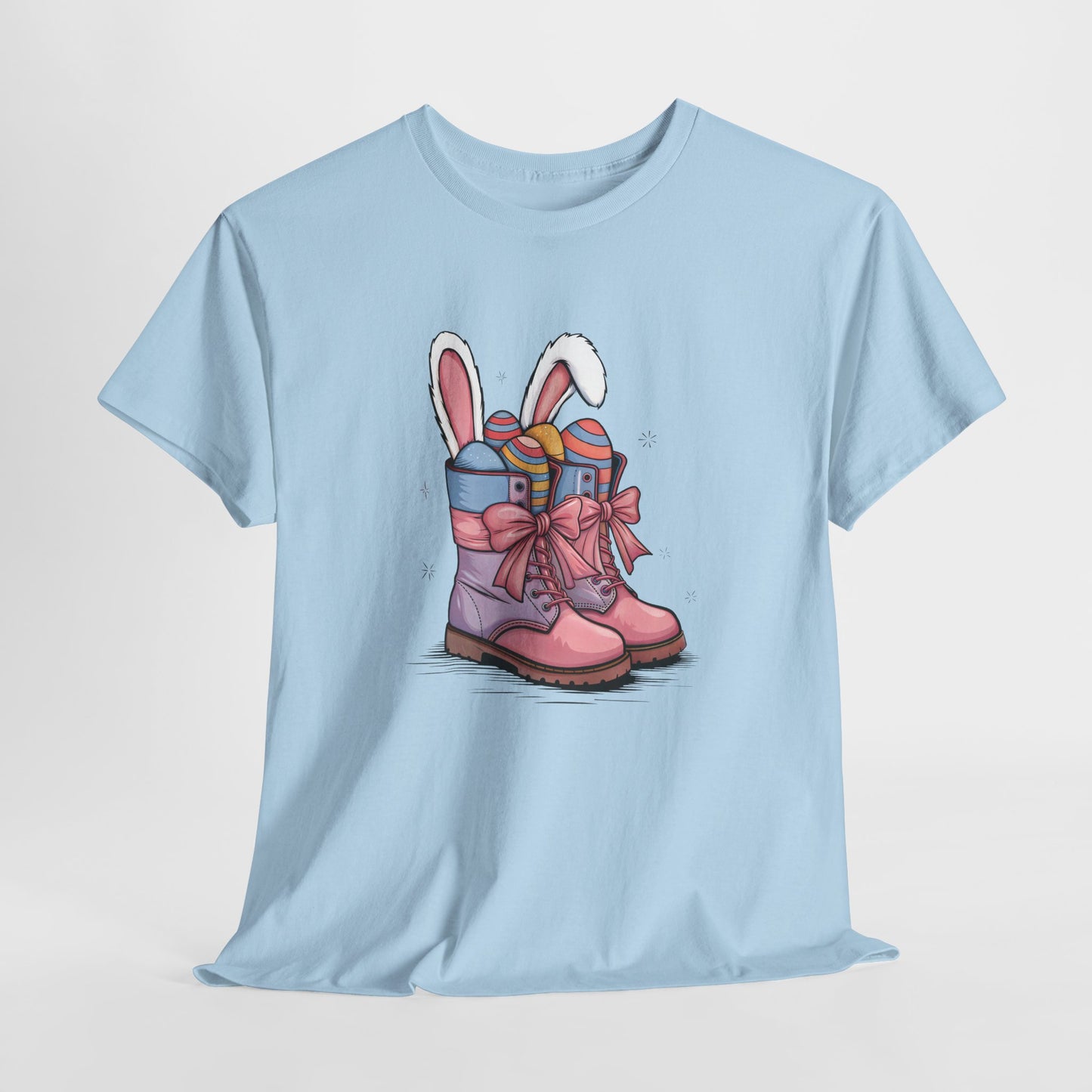 Light Blue T-shirt hanging, displaying an Easter cowgirl boots design with bunny ears and eggs, a cute springtime look. Hop into the season in style and shop Easter shirts online today!
