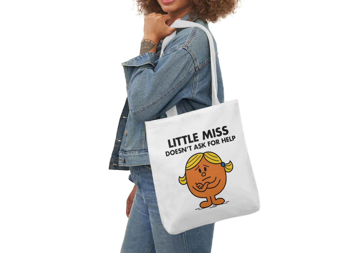 Woman in denim modeling the Little Miss Doesn’t Ask For Help tote on her shoulder. She’s got it covered. Definitely. Probably. Part of the Vivid Divergence Little Miss Meme Collection!