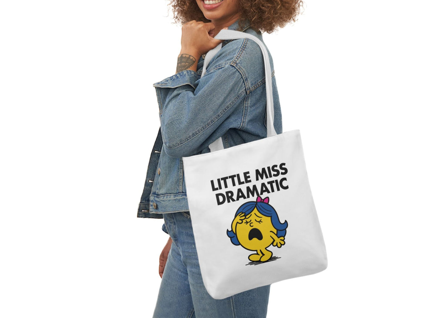Woman in denim modeling the Little Miss Dramatic tote bag over her shoulder. She’s ready to turn a minor inconvenience into a major plot twist. Part of the Vivid Divergence Little Miss Meme Collection!