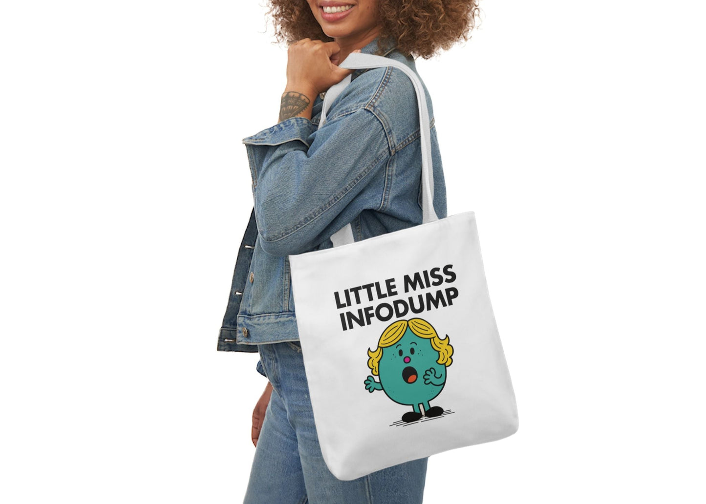 Woman in denim modeling the Little Miss Infodump tote over her shoulder. She’s five tangents deep and still going strong. Part of the Vivid Divergence Little Miss Meme Collection!