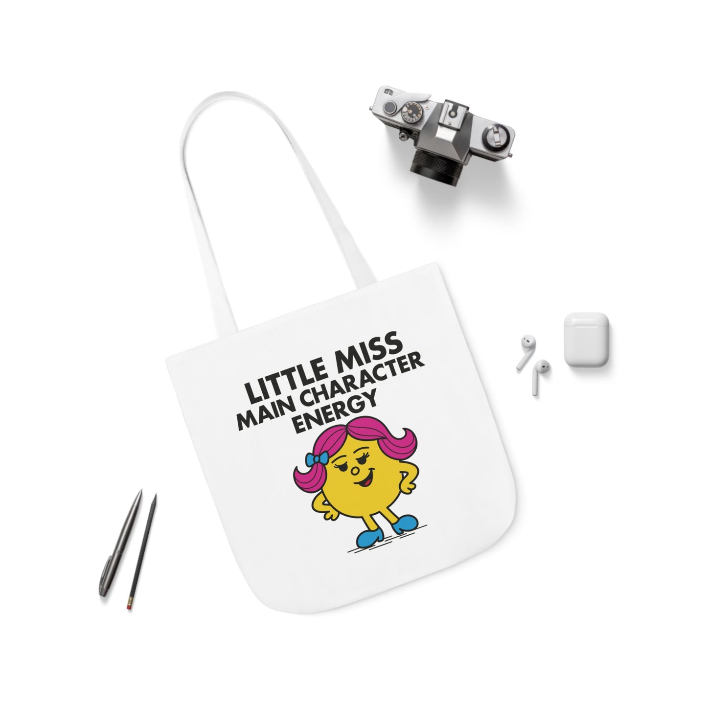 Flat lay of tote bag with accessories, showing "Little Miss Main Character Energy" graphic and bold character. Part of the Vivid Divergence Little Miss Meme Collection!