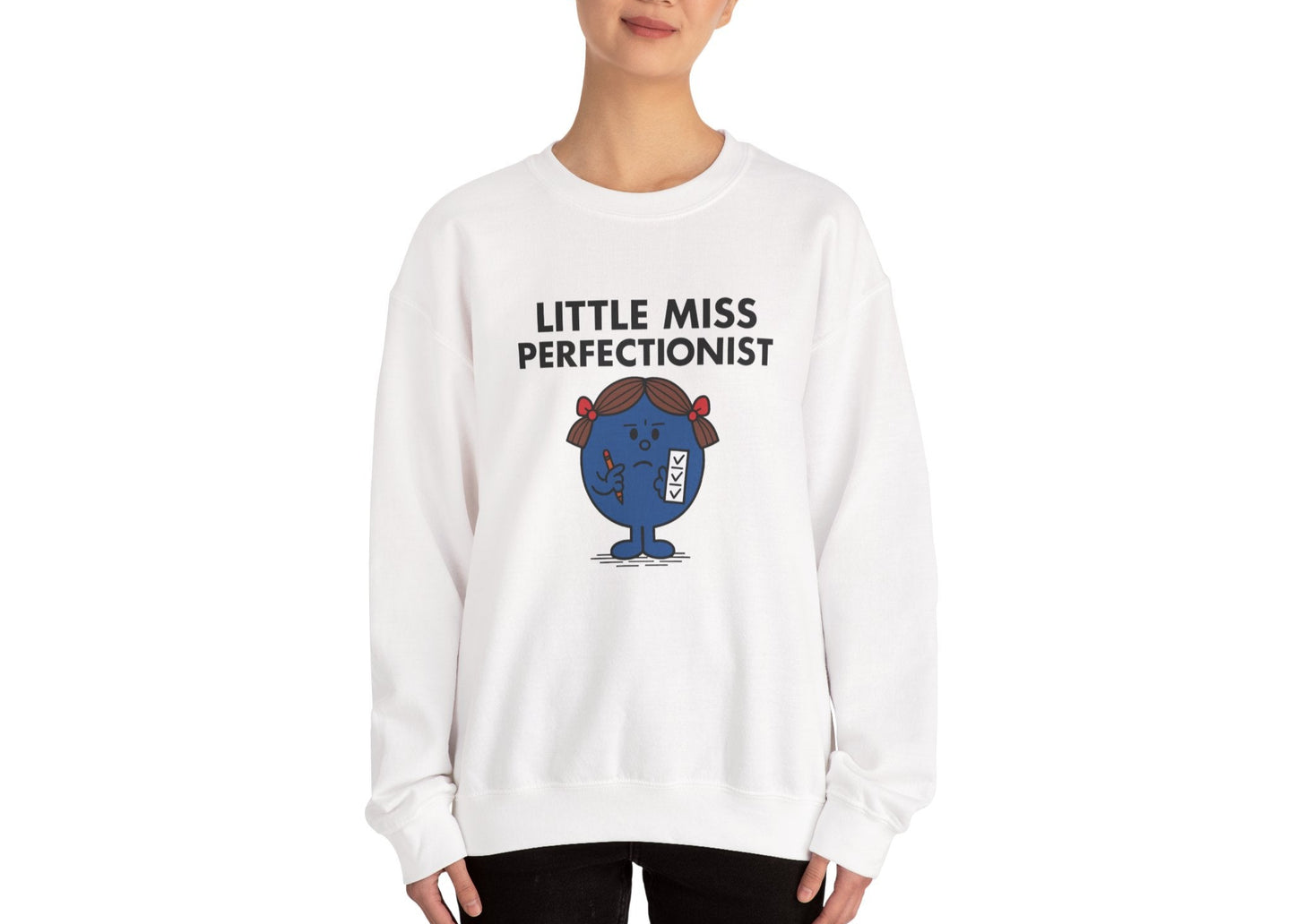 Person wearing the Little Miss Perfectionist sweatshirt in a front-facing pose. Part of the Little Miss Meme Character Collection. A Vivid Divergence Sensory Friendly Sweater Jumper.