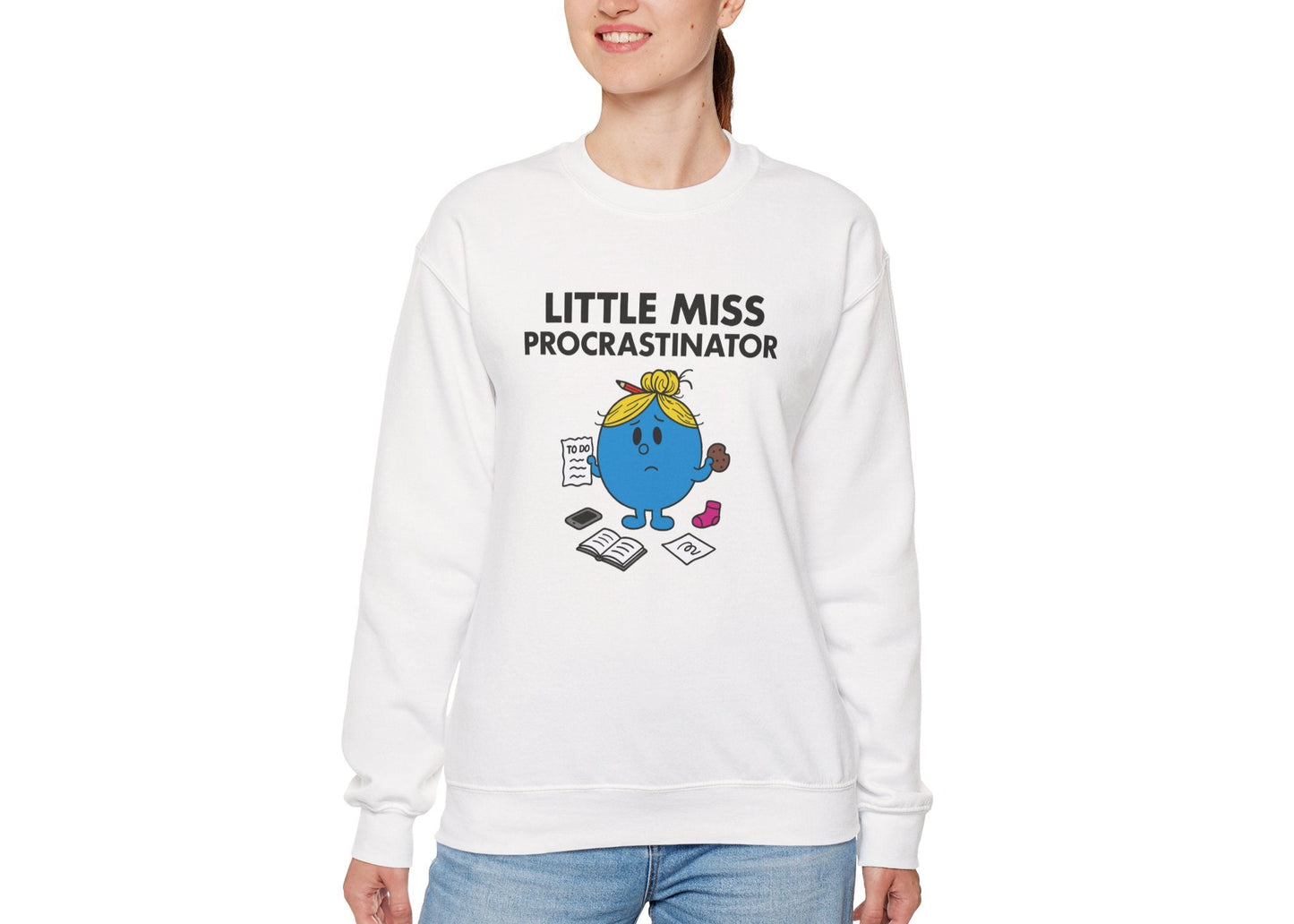 Person wearing the Little Miss Procrastinator sweatshirt with blue jeans. Part of the Little Miss Meme Character Collection. A Vivid Divergence Sensory Friendly Sweater Jumper.