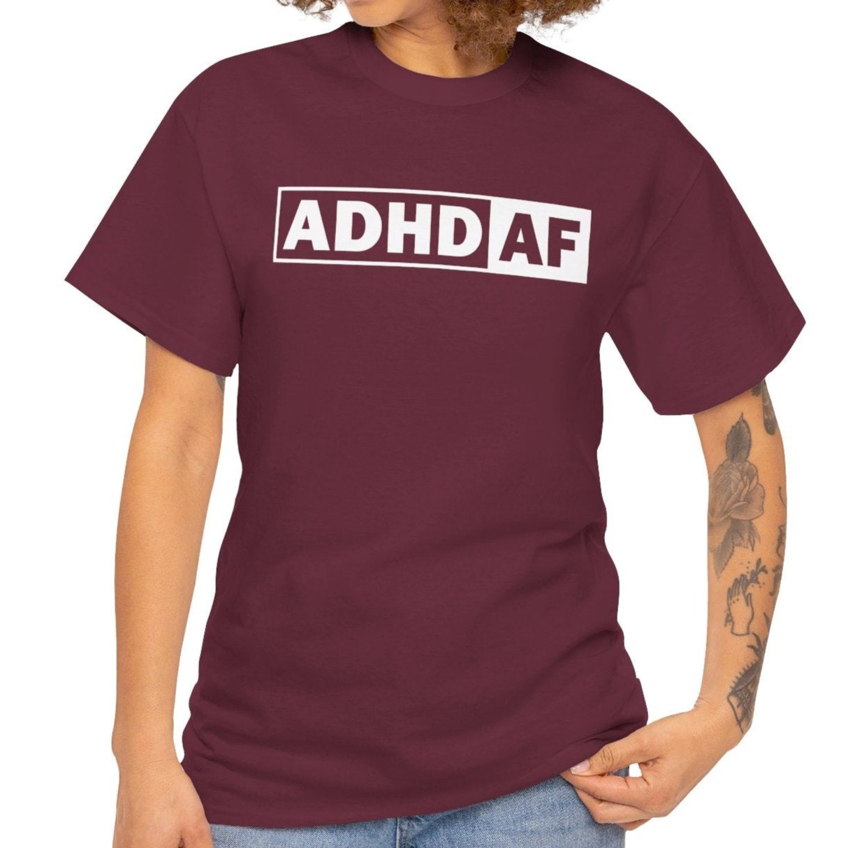 Model wearing a maroon T-shirt with bold "ADHD AF" text. Part of the Vivid Divergence Sensory Friendly Unisex Tees Range.