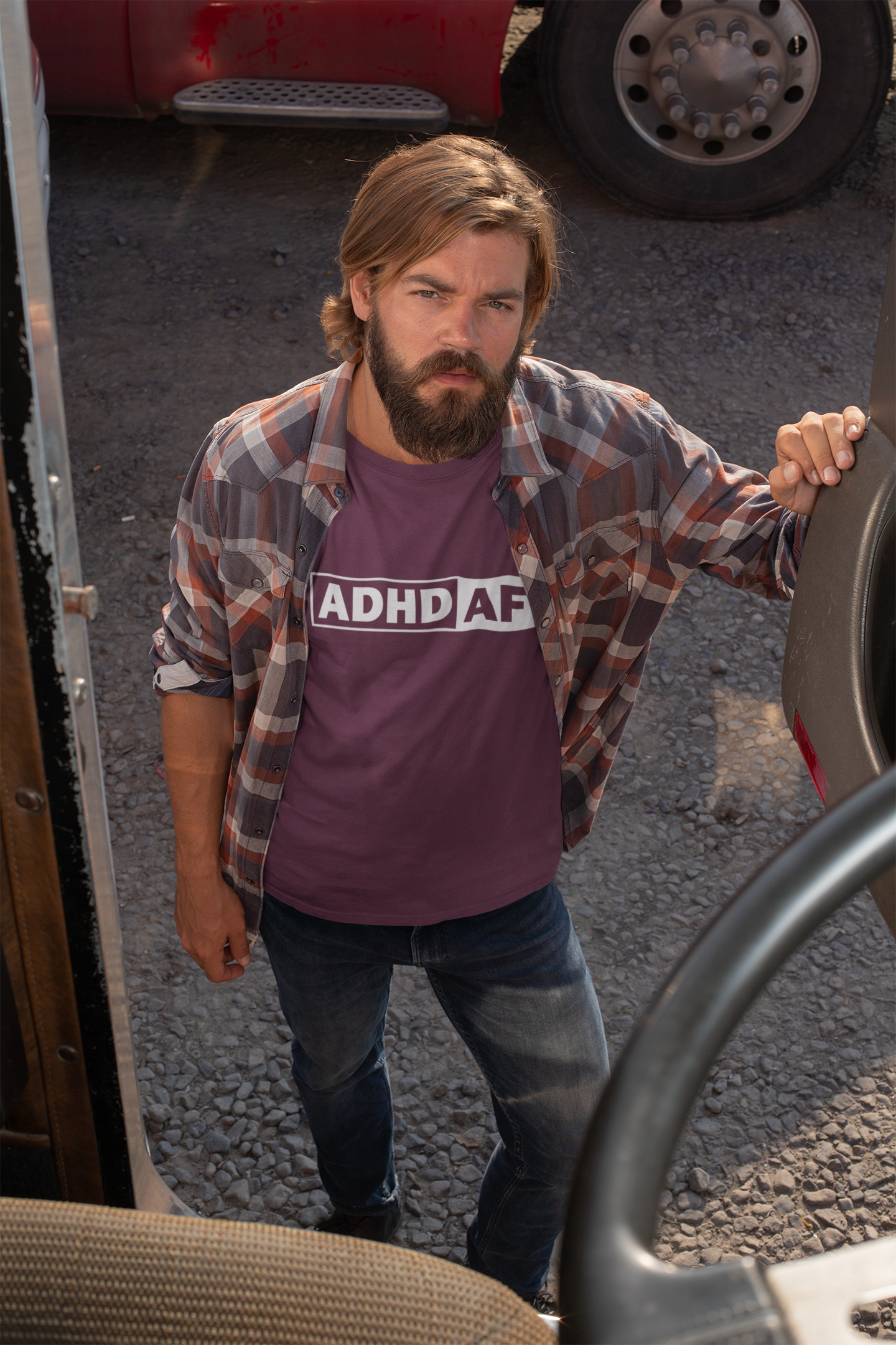 Model wearing a maroon T-shirt with bold "ADHD AF" text. Part of the Vivid Divergence Sensory Friendly Unisex Tees Range.