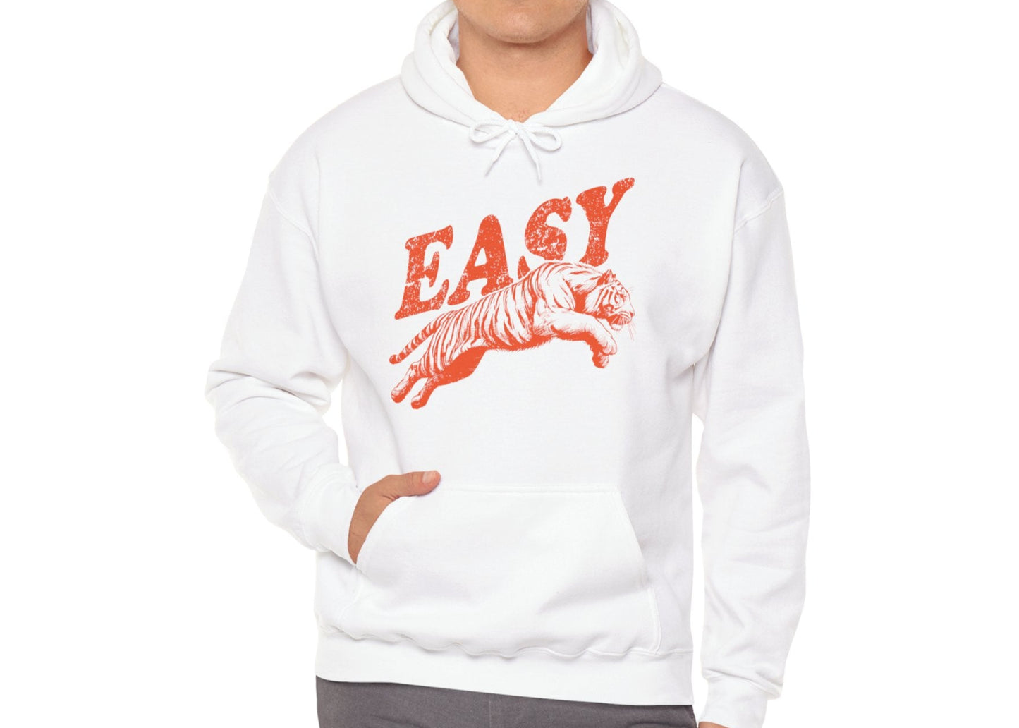 Model wearing a white hoodie with "EASY" in ORANGE letters and a leaping tiger graphic, standing with hands at sides. Part of the Vivid Divergence Sensory Friendly Unisex Hoodie Range.