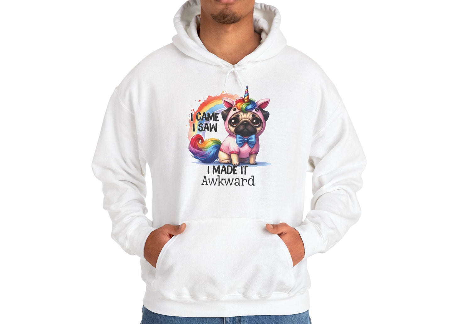 Model wearing a white hoodie with a colorful unicorn pug and the text "I Came, I Saw, I Made It Awkward," standing with hands at sides. Part of the Vivid Divergence Sensory Friendly Unisex Hoodie Range.