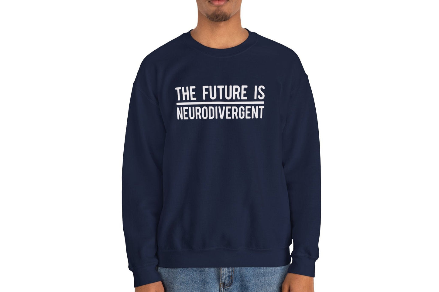 Model wearing a navy blue sweater jumper with the text "The Future is Neurodivergent" in bold white lettering. Part of the Vivid Divergence Sensory Friendly Unisex Sweater Jumper Range.
