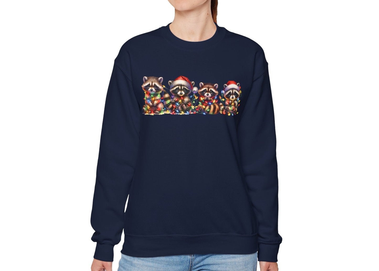 Model wearing a navy blue sweatshirt featuring a festive illustration of raccoons in Christmas attire causing holiday chaos. Part of the Vivid Divergence Sensory Friendly Unisex Sweater Jumper Range.