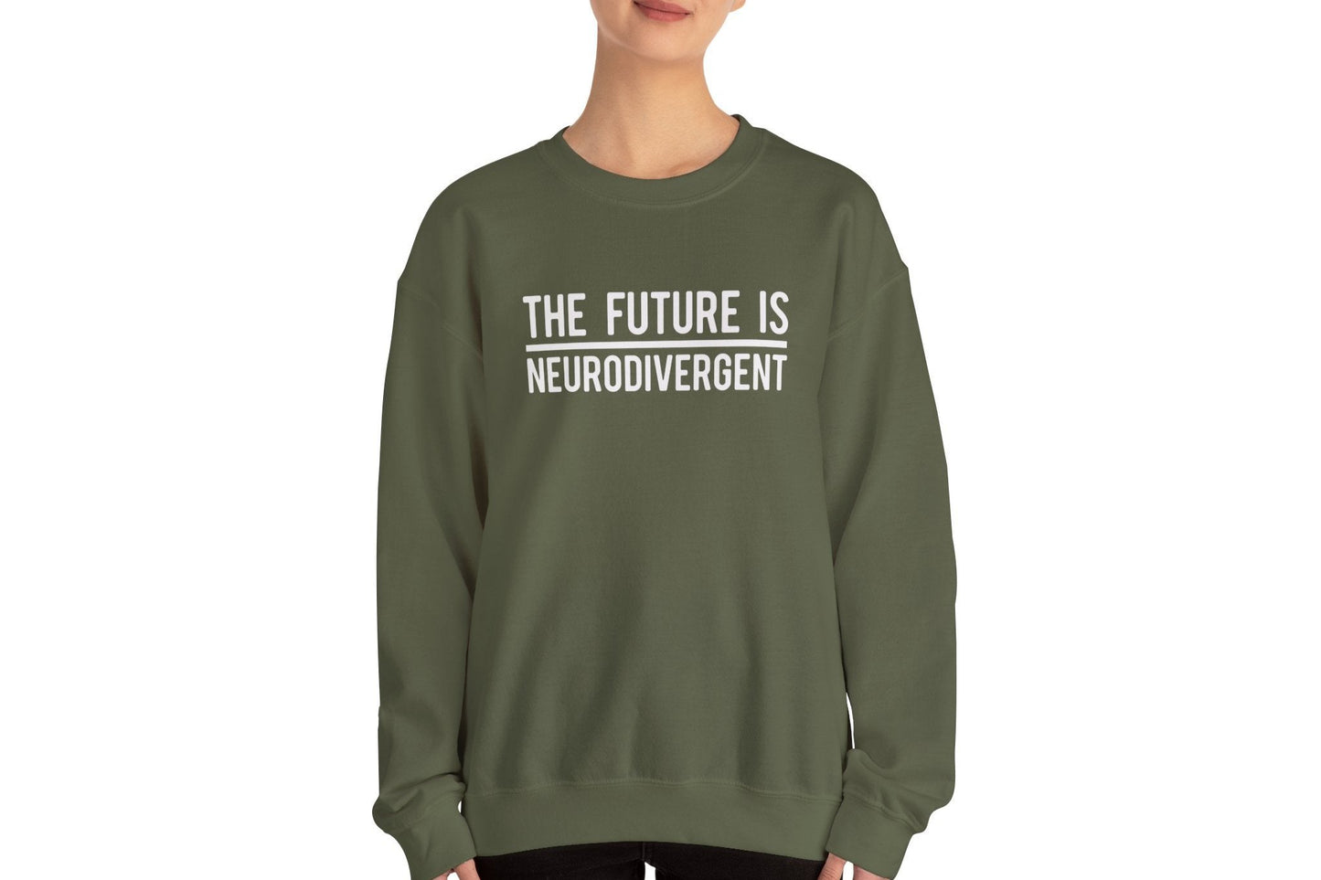 Model wearing a olive green sweater jumper with the text "The Future is Neurodivergent" in bold white lettering. Part of the Vivid Divergence Sensory Friendly Unisex Sweater Jumper Range.