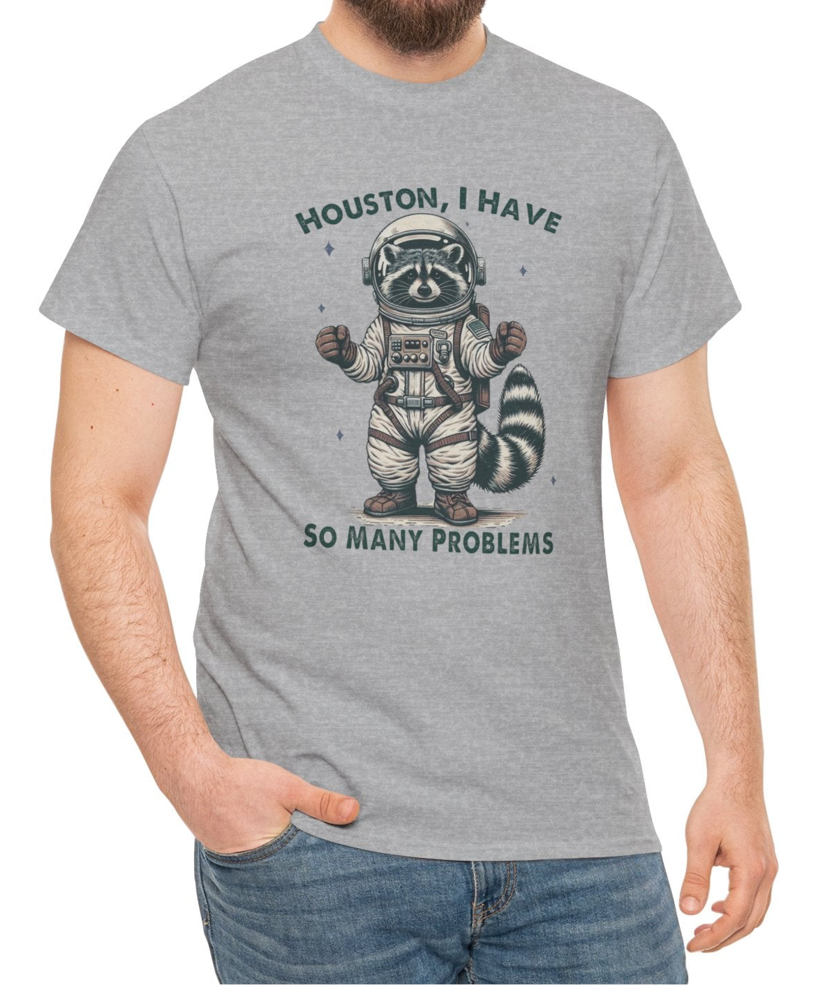 A person wearing a gray T-shirt with an astronaut raccoon graphic and the text "Houston, I Have So Many Problems." Part of the Vivid Divergence Sensory Friendly Unisex Tees Range.