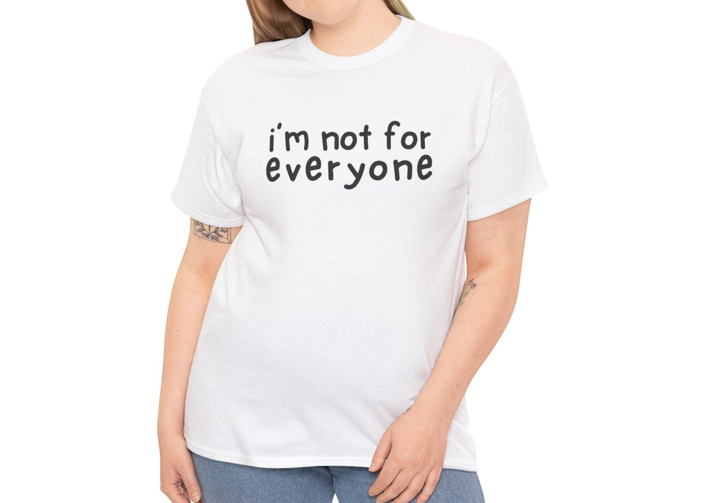 A person wearing a white T-shirt with the text "I'm Not For Everyone" in black lettering. Part of the Vivid Divergence Sensory Friendly Unisex Tees Range.