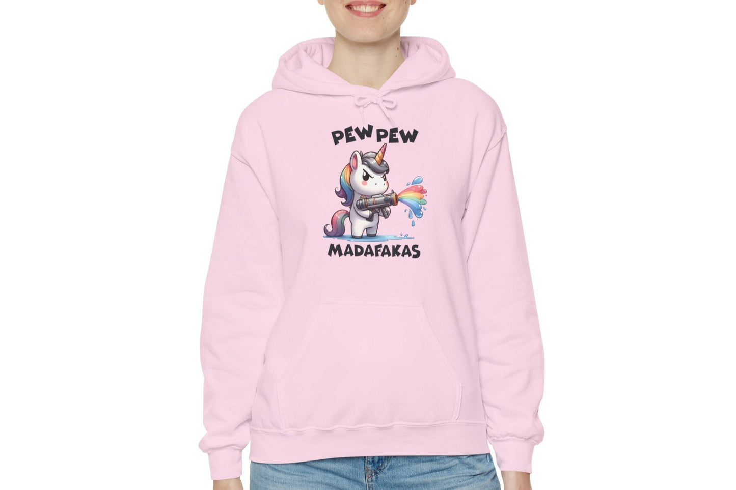 Model wearing a pink hoodie featuring the text "Pew Pew Madafakas" and a cartoon illustration of a unicorn holding a rainbow water gun. Part of the Vivid Divergence Sensory Friendly Unisex Hoodie Range.