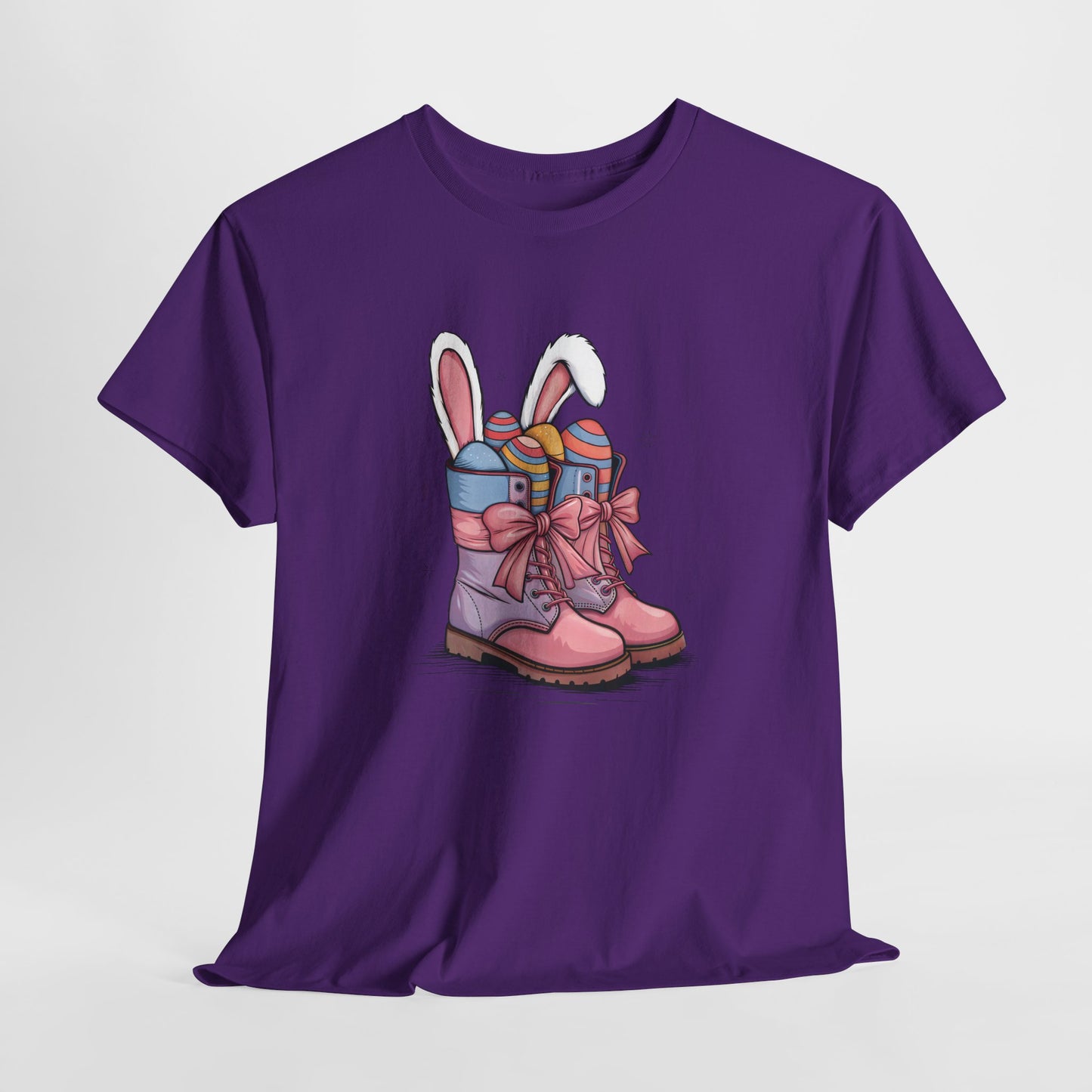 Purple T-shirt hanging, showcasing a cute cowgirl boots design with bunny ears and colorful Easter eggs, a fun holiday outfit. Hop into the season in style and shop Easter shirts online today!