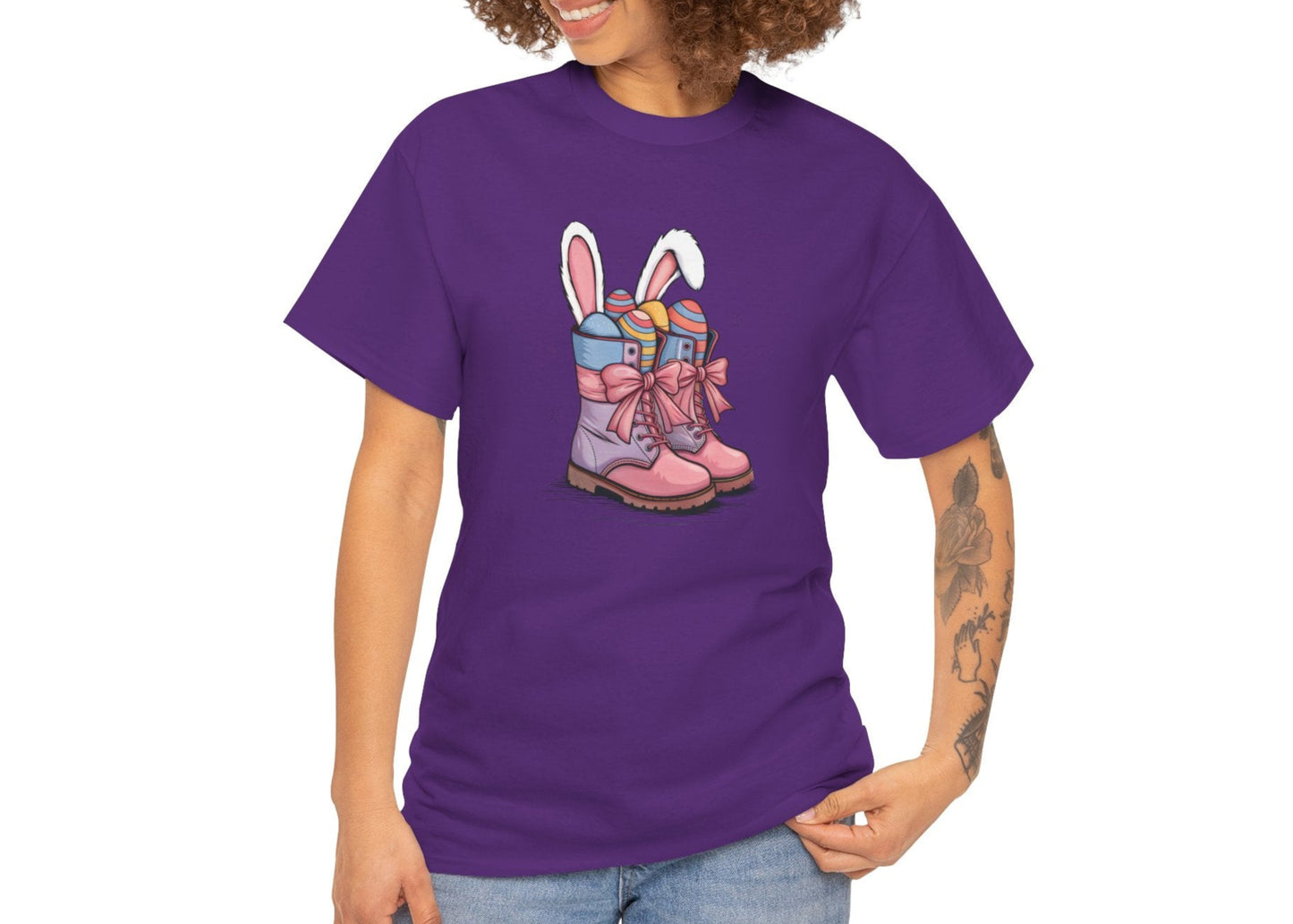 Woman wearing a Purple Easter T-shirt showcasing cowgirl boots filled with Easter eggs and bunny ears, perfect for a stylish holiday outfit. Hop into the season in style and shop Easter shirts online today!