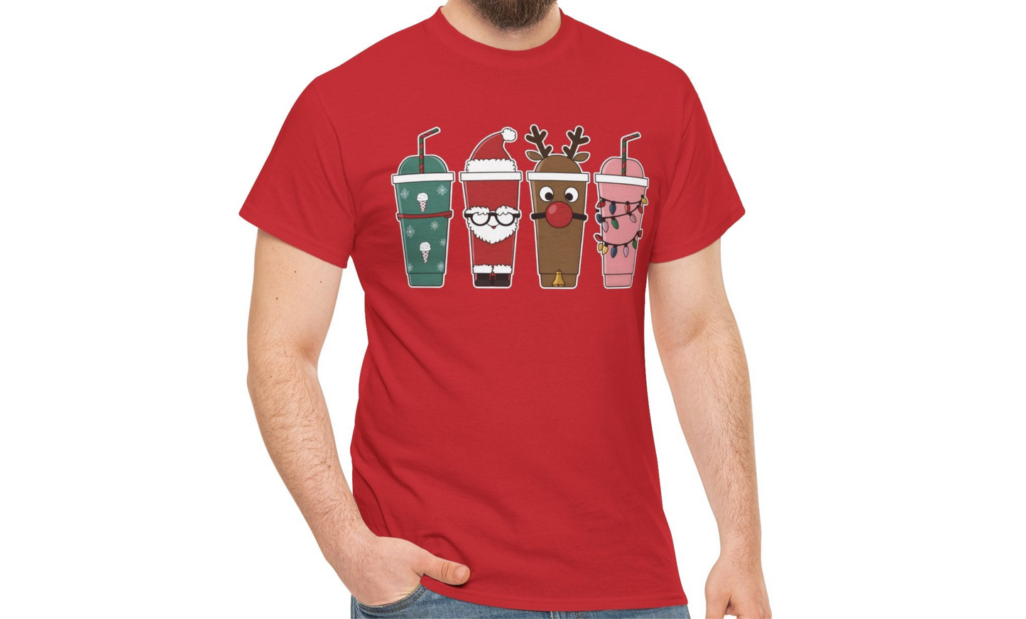 Model wearing a red T-shirt featuring a festive illustration of four iced coffee cups decorated with Christmas designs, styled in a cozy indoor setting. Part of the Vivid Divergence Sensory Friendly Unisex Tees Range.