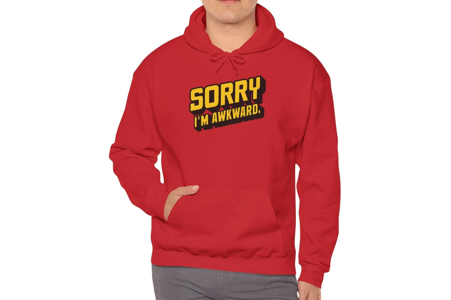 Model wearing a red hoodie featuring the text "Sorry I'm Awkward" in bold yellow and white lettering. Part of the Vivid Divergence Sensory Friendly Unisex Hoodie Range.