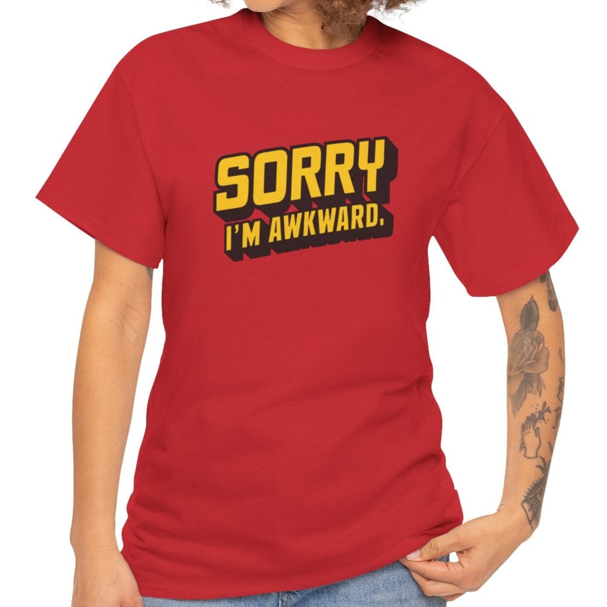 Model wearing a red T-shirt with "Sorry I'm Awkward" in bold yellow text. Part of the Vivid Divergence Sensory Friendly Unisex Tees Range.