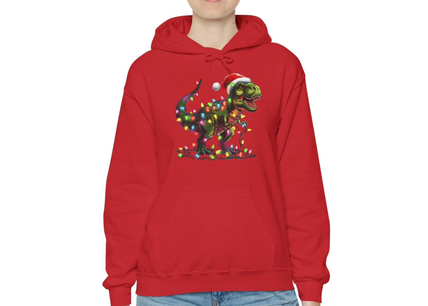 Model wearing a red hoodie featuring a festive T-Rex wrapped in Christmas lights with a Santa hat. Part of the Vivid Divergence Sensory Friendly Hoodie Range.