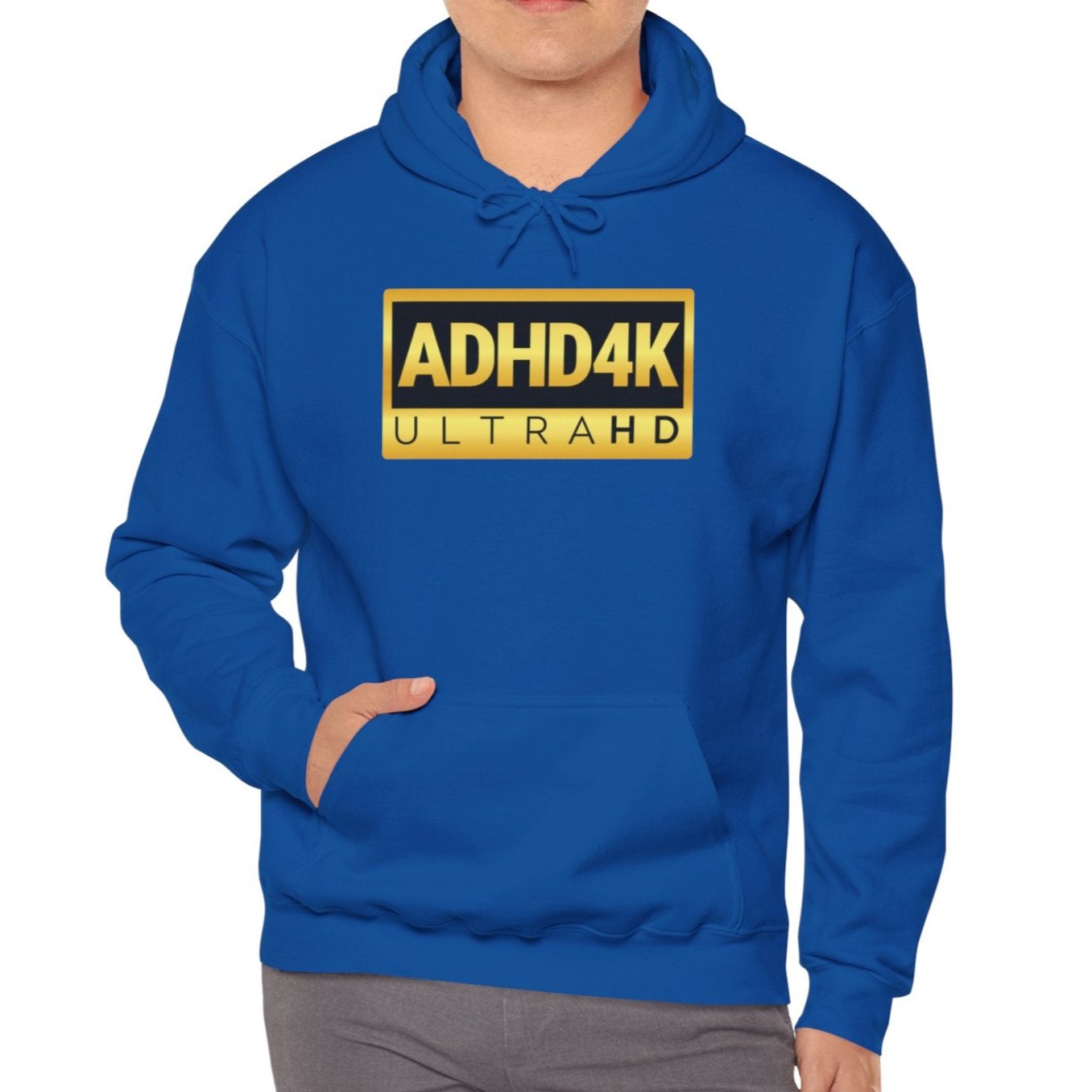 Model wearing a royal blue hoodie with the text "ADHD4K UltraHD" in bold yellow and black lettering inside a rectangular design. Part of the Vivid Divergence Sensory Friendly Unisex Hoodie Range.