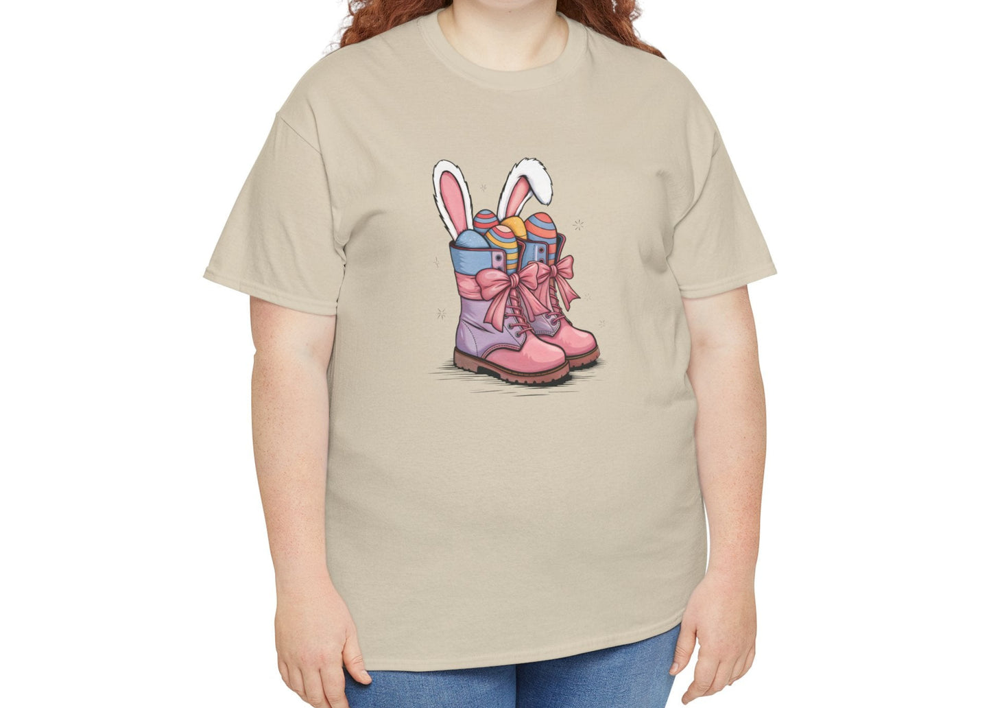 Woman wearing a Sand Easter T-shirt showcasing a rustic cowgirl boots design with bunny ears and eggs, a charming holiday tee. Hop into the season in style and shop Easter shirts online today!