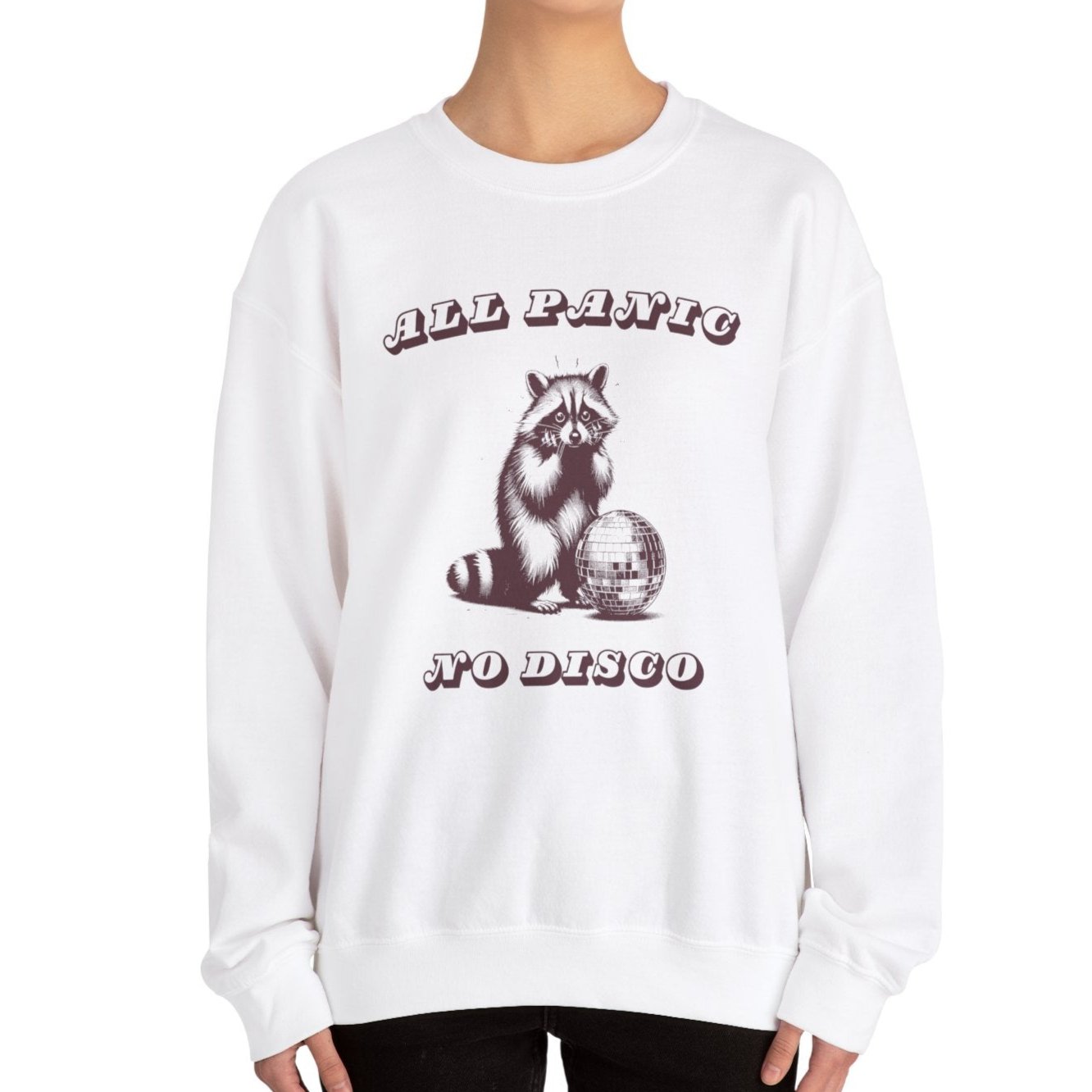 Model wearing a white sweater jumper with a "All Panic No Disco" design featuring a raccoon illustration. Part of the Vivid Divergence Sensory Friendly Unisex Sweater Jumper Range.