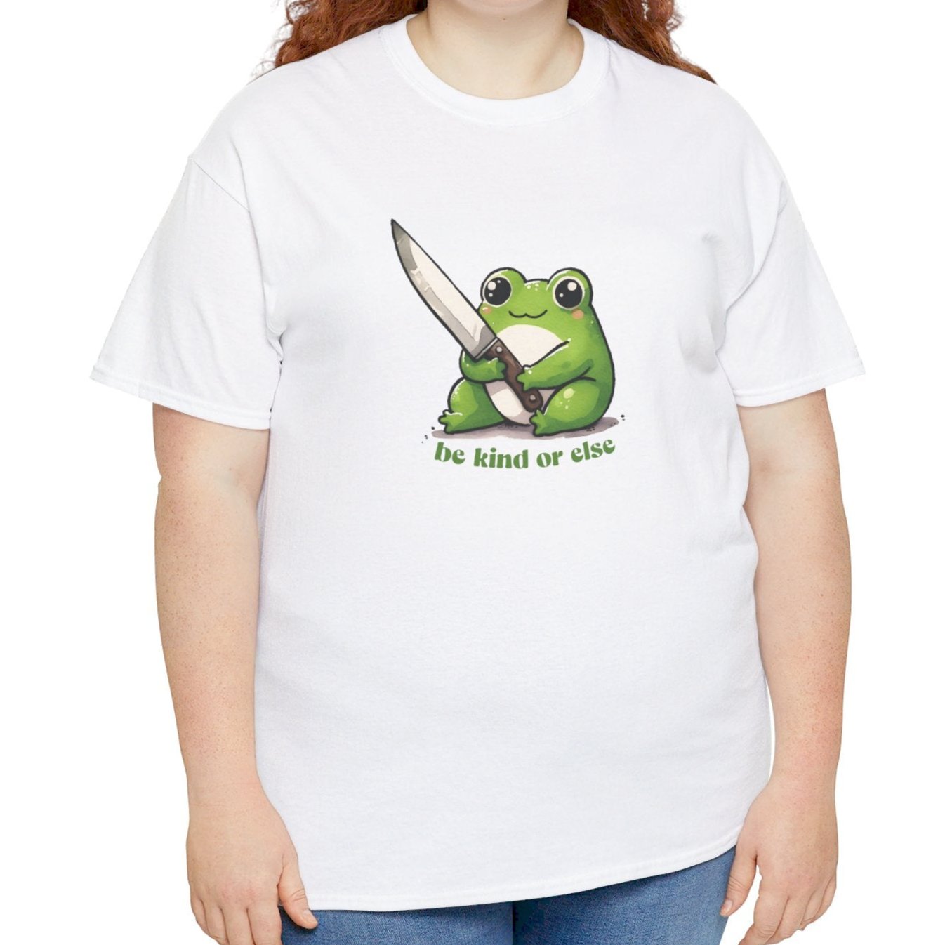 White T-shirt featuring a green frog holding a knife with the text "Be Kind or Else," modeled by a person standing. Part of the Vivid Divergence Sensory Friendly Unisex Tees Range.