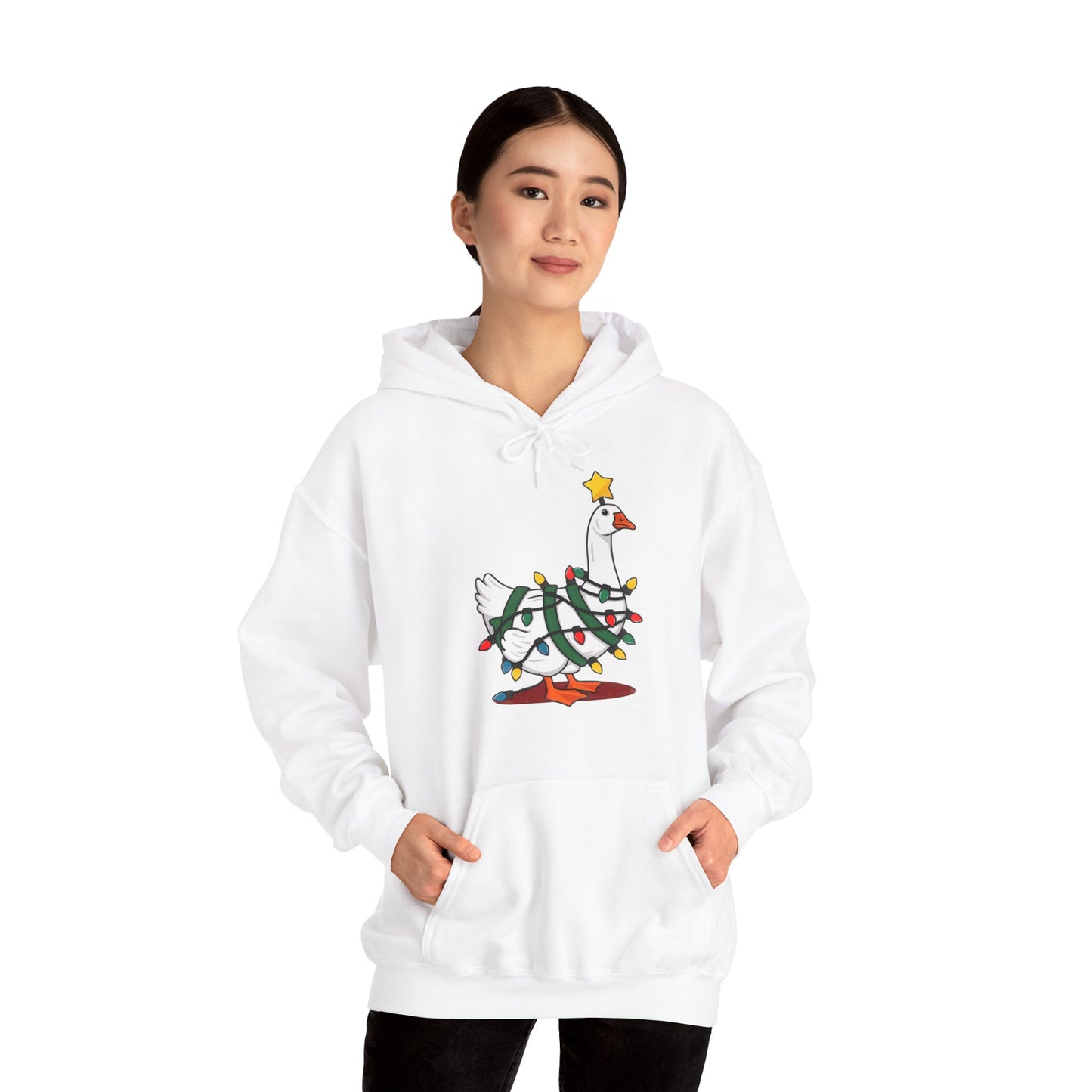 Model wearing a white hoodie featuring a festive illustration of a goose wearing a Santa hat and stringing Christmas lights, with the text "Goose on the Loose." Part of the Vivid Divergence Sensory Friendly Unisex Hoodie Range.